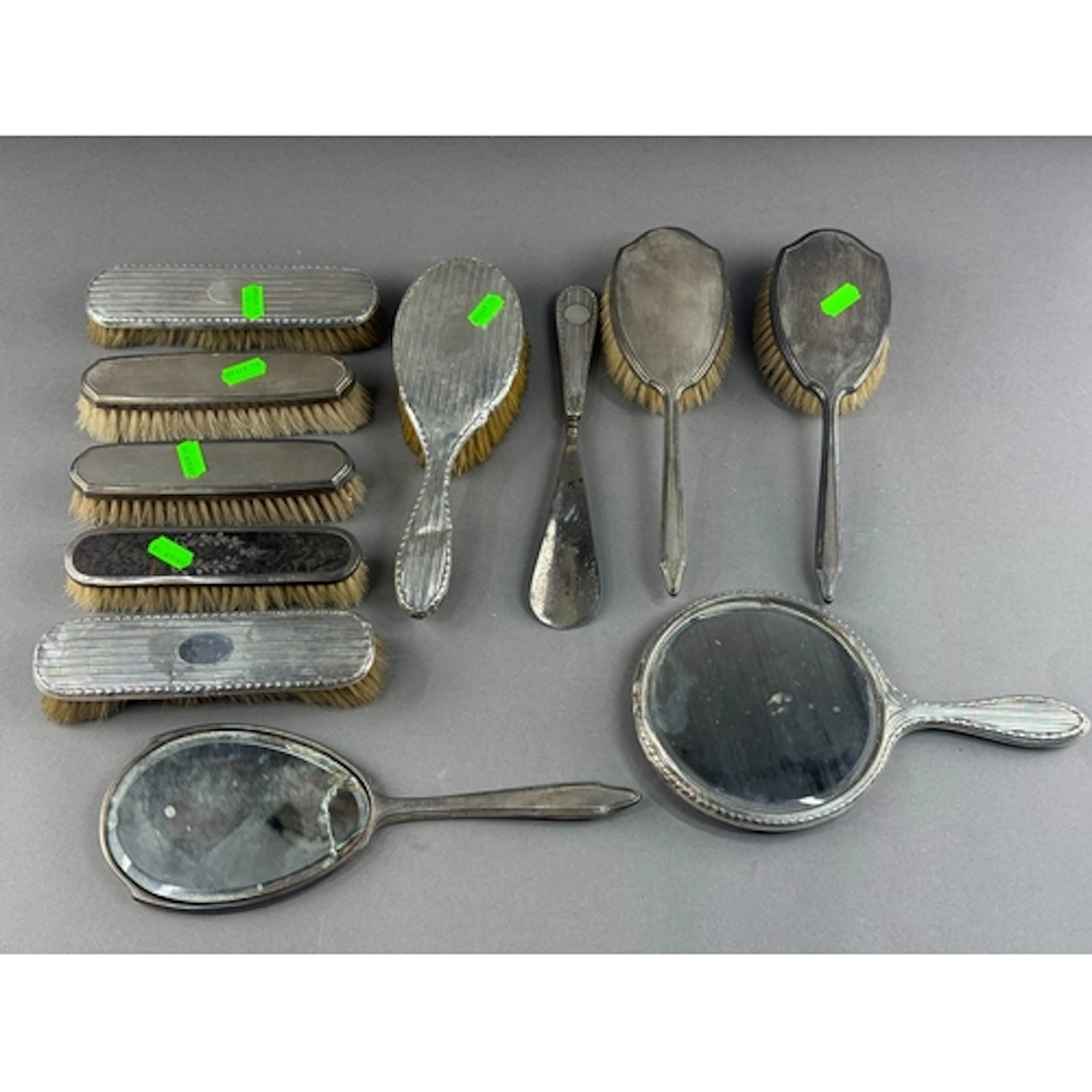 Silver: a group of dressing table items, to include two mirr...