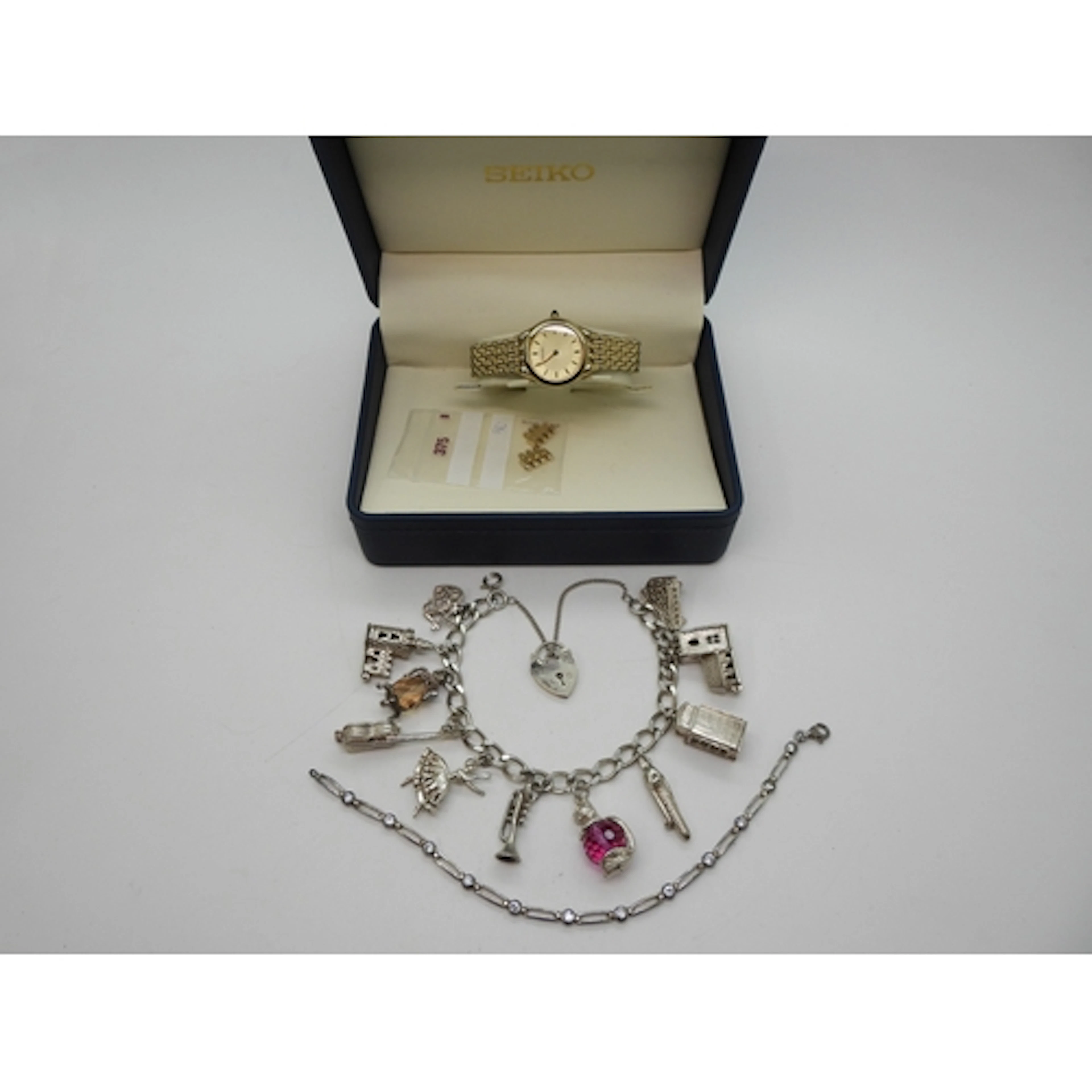 A silver and white metal Charm bracelet to include five larg...