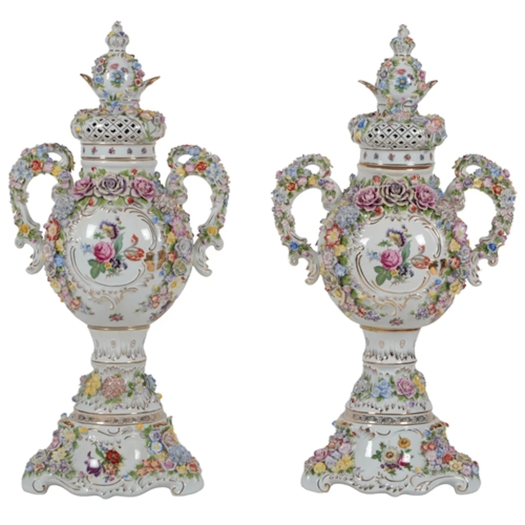 A massive pair of German porcelain floral encrusted vases an...