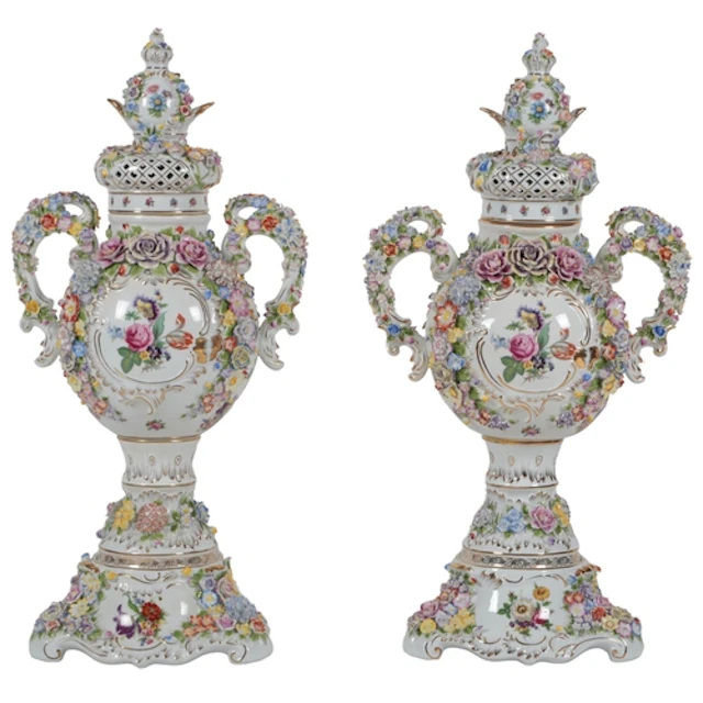 A massive pair of German porcelain floral encrusted vases an...