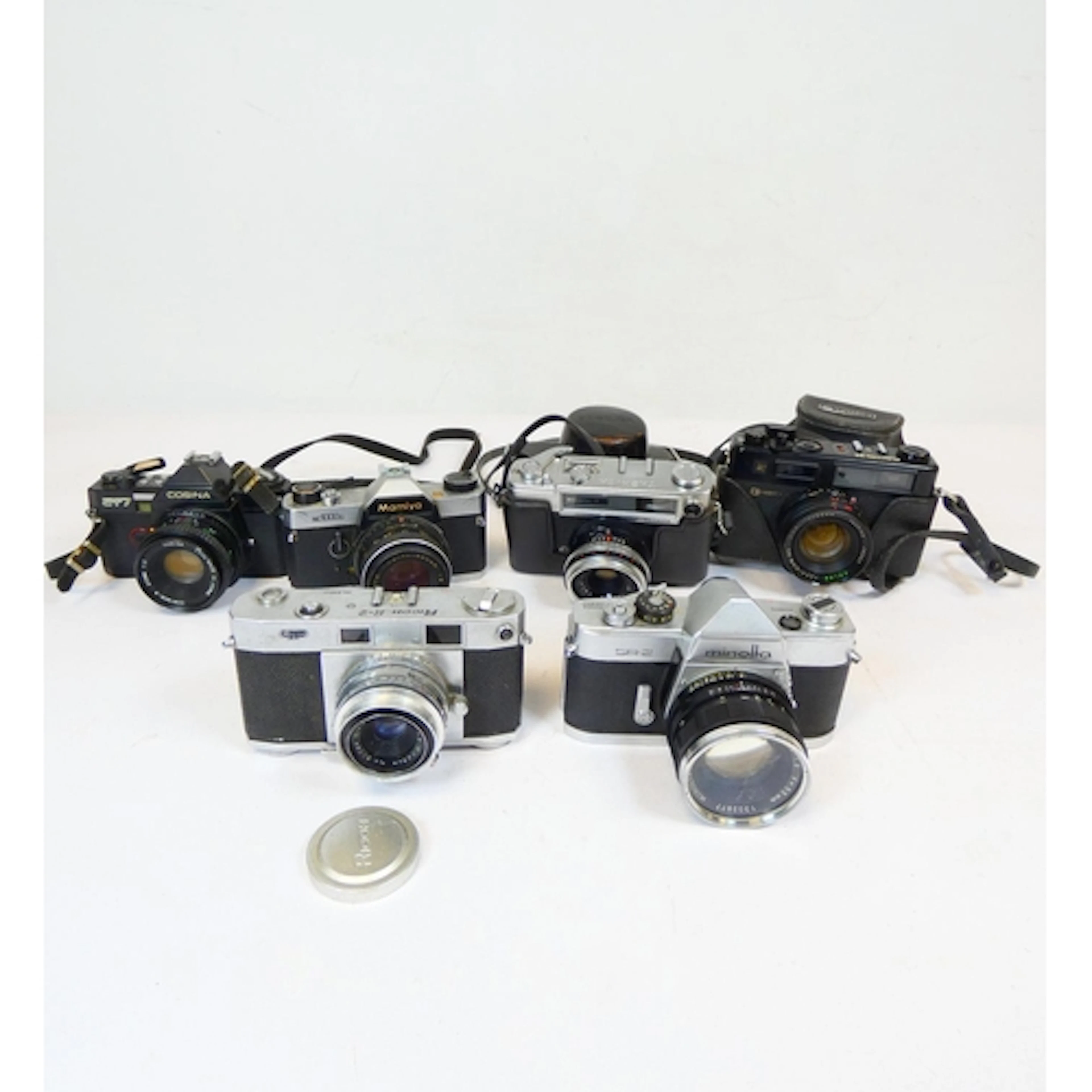 Group of vintage 35mm SLR film cameras with lenses to includ...