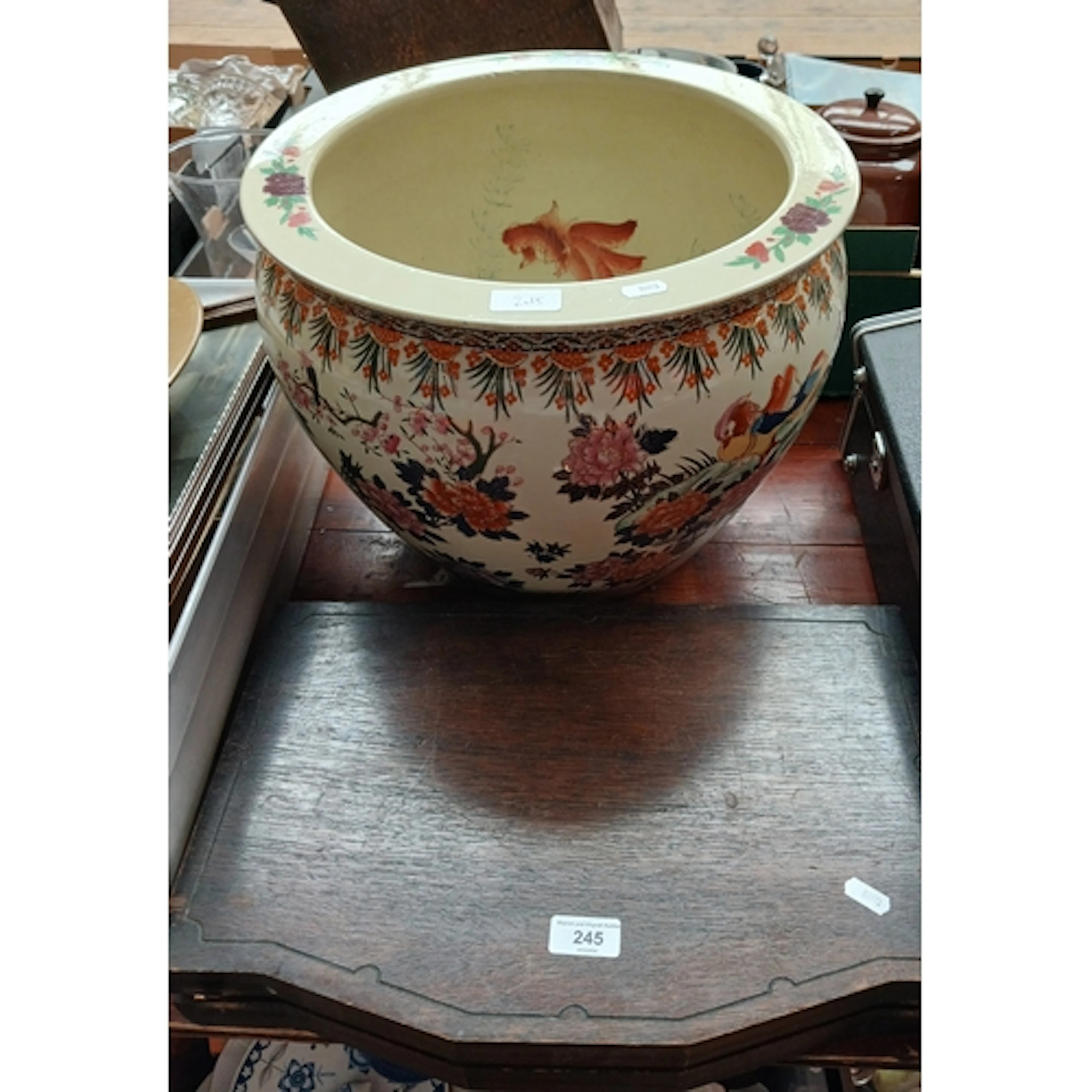 A large ceramic oriental fish bowl and a canteen of Thai bro...