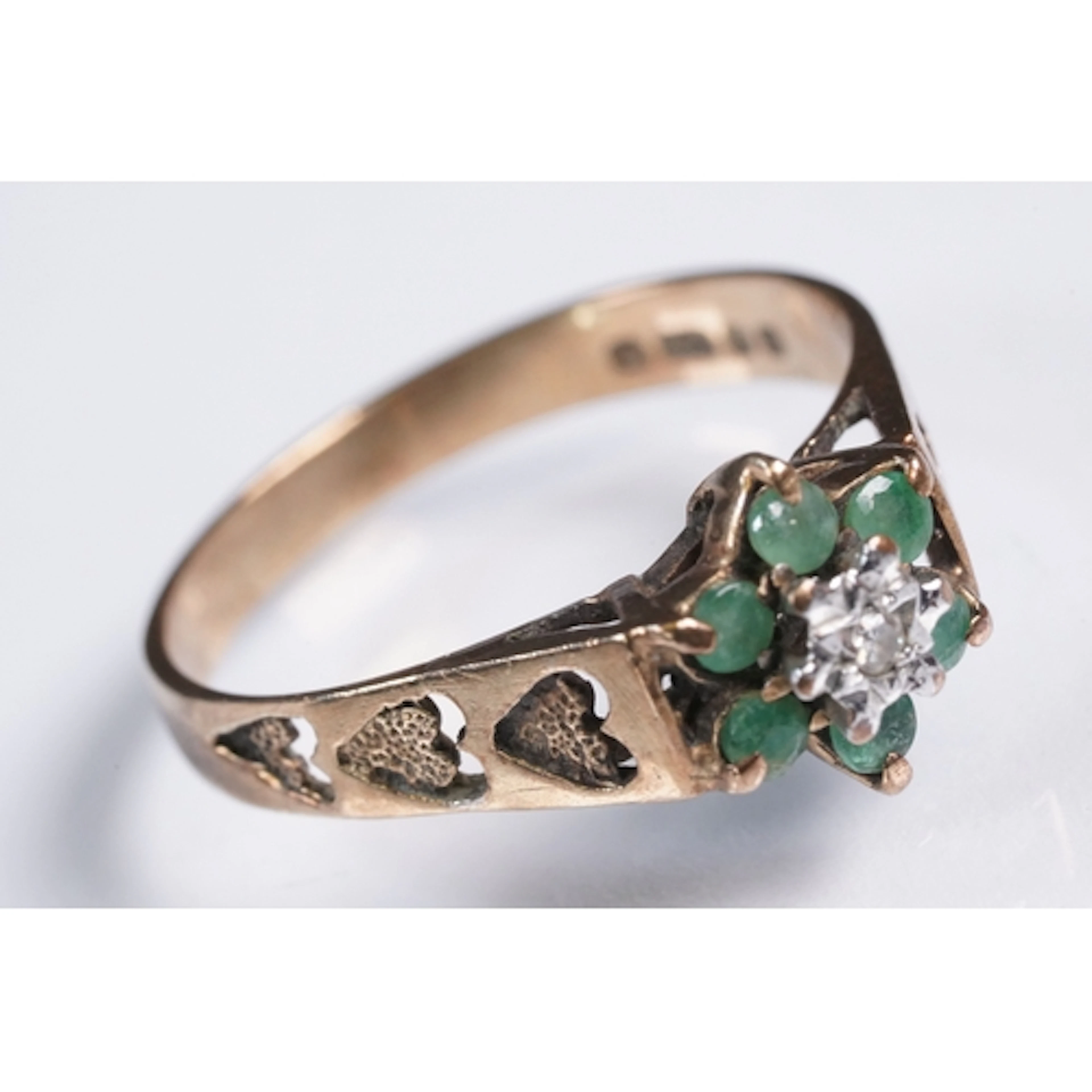 9ct gold, emerald and diamond ring. The ring being set with ...