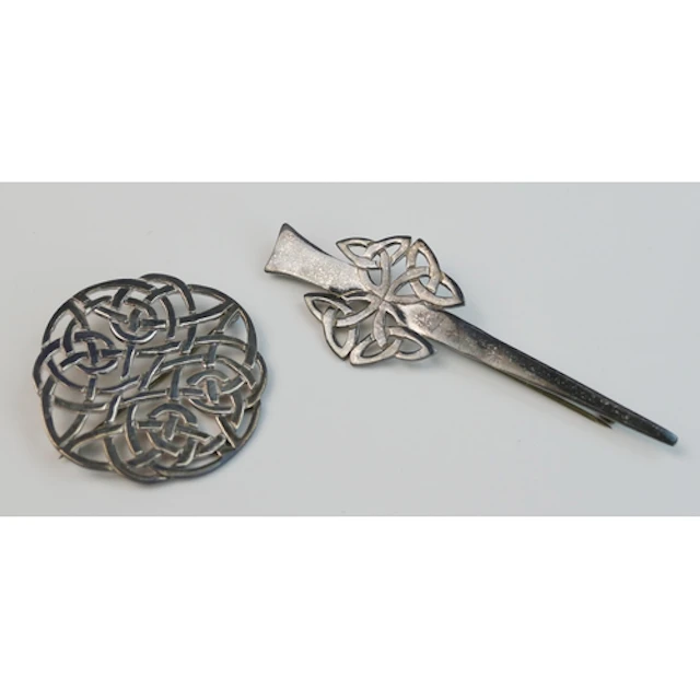 Two Scottish silver brooches with pierced decoration, one by...