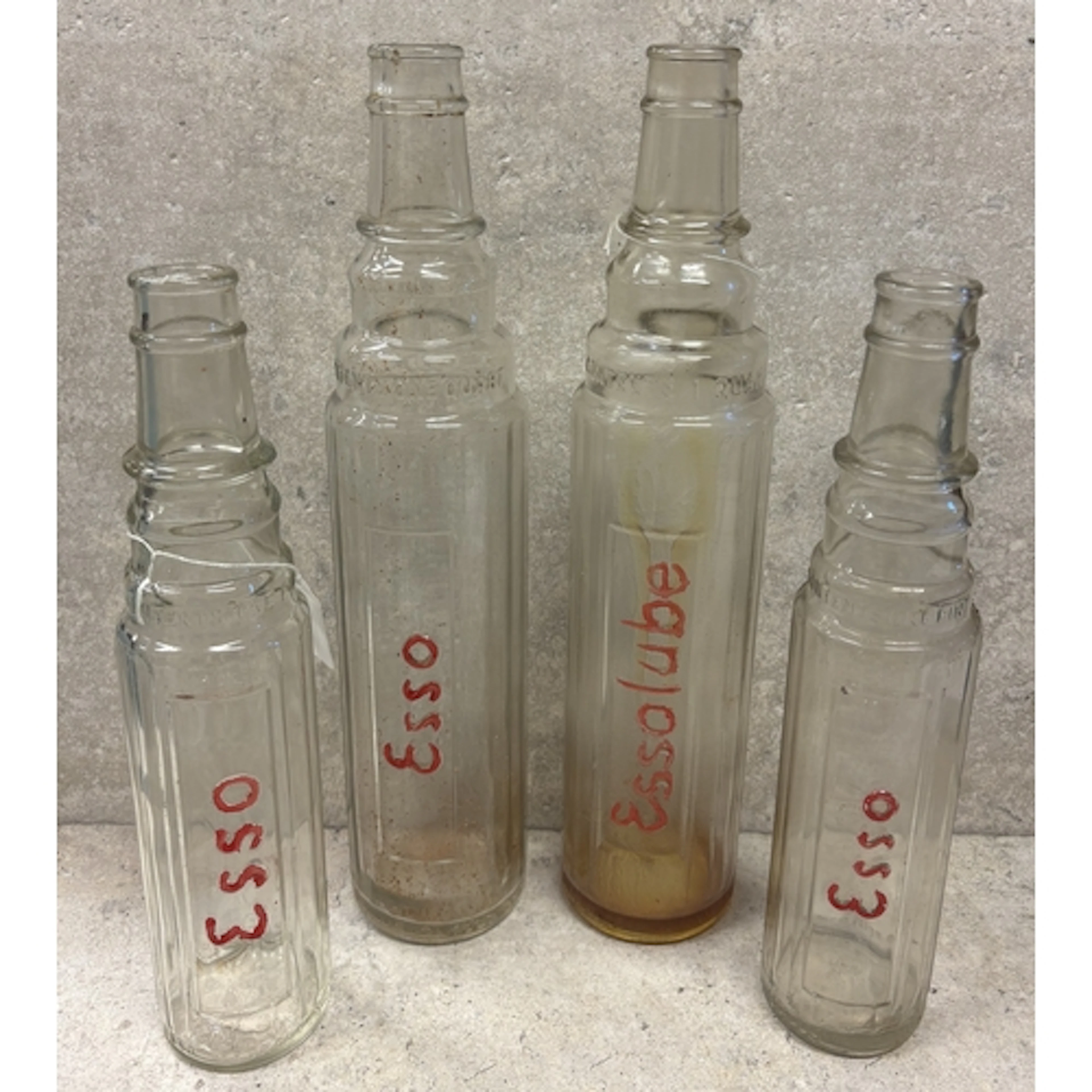 Two quart Esso Motor Oil glass bottles together with two pin...