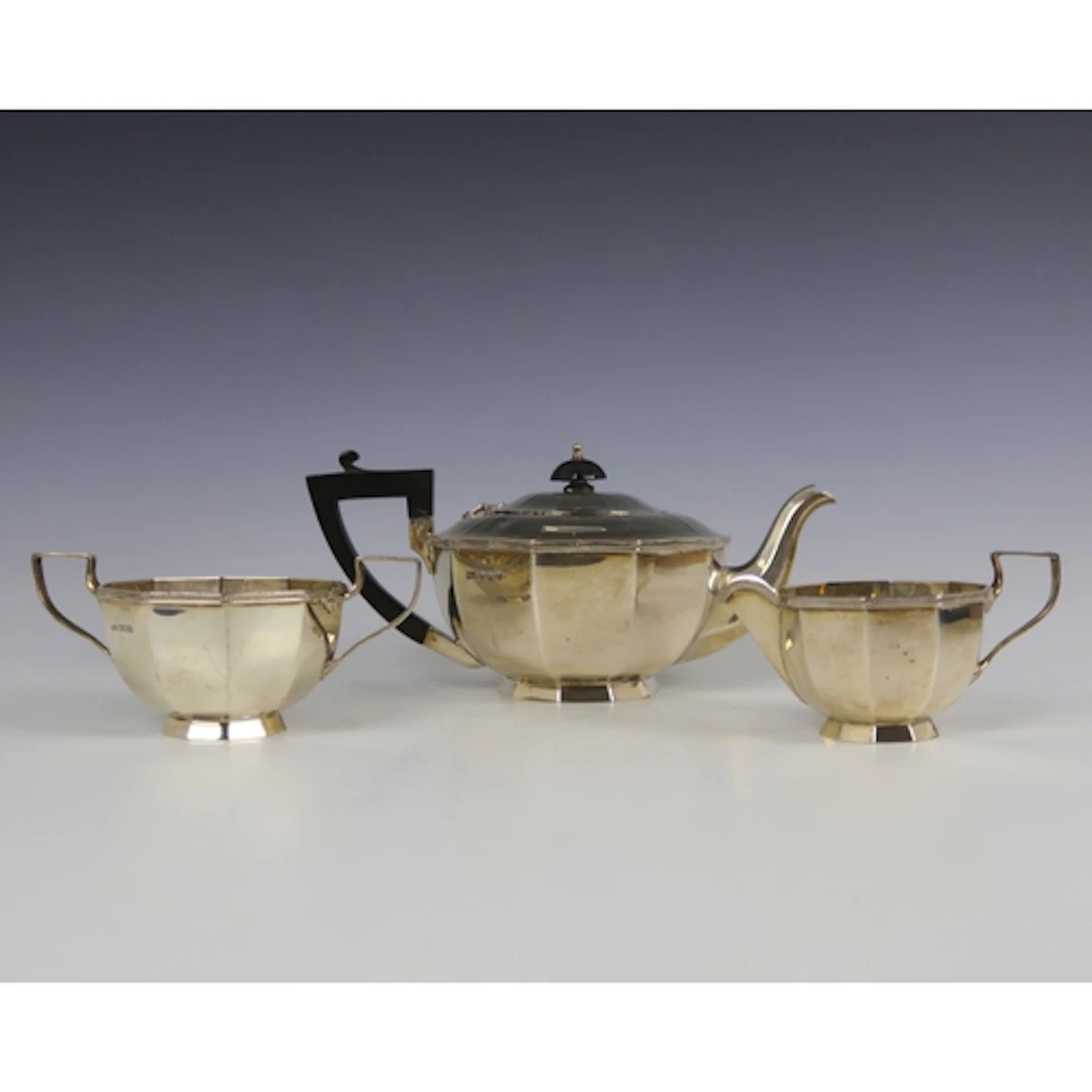 A George V silver three piece tea service, Walker & Hall, Sh...