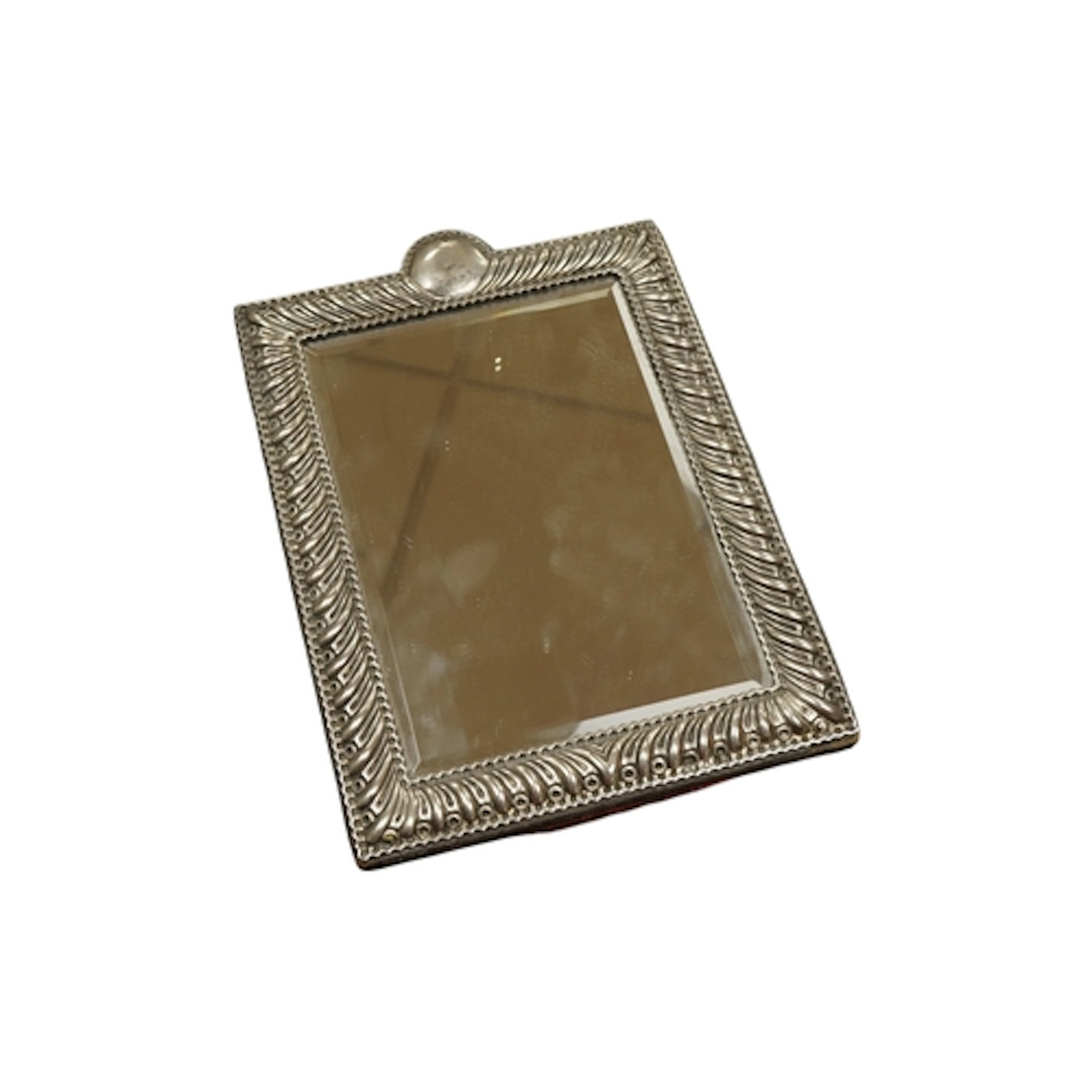 A silver framed table mirror, maker William Comyns, with bev...