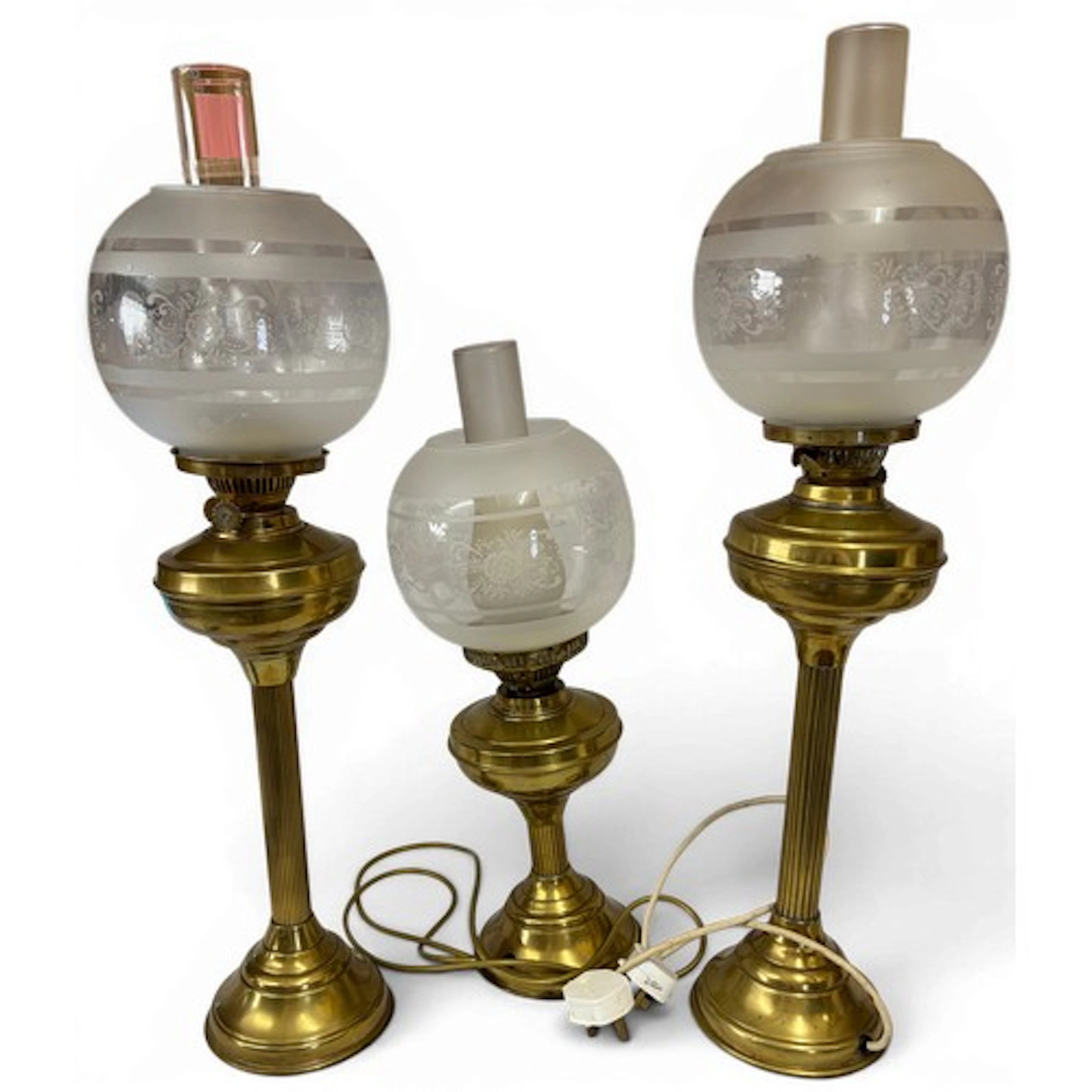 A pair of tall brass table lamps (one converted to electrici...