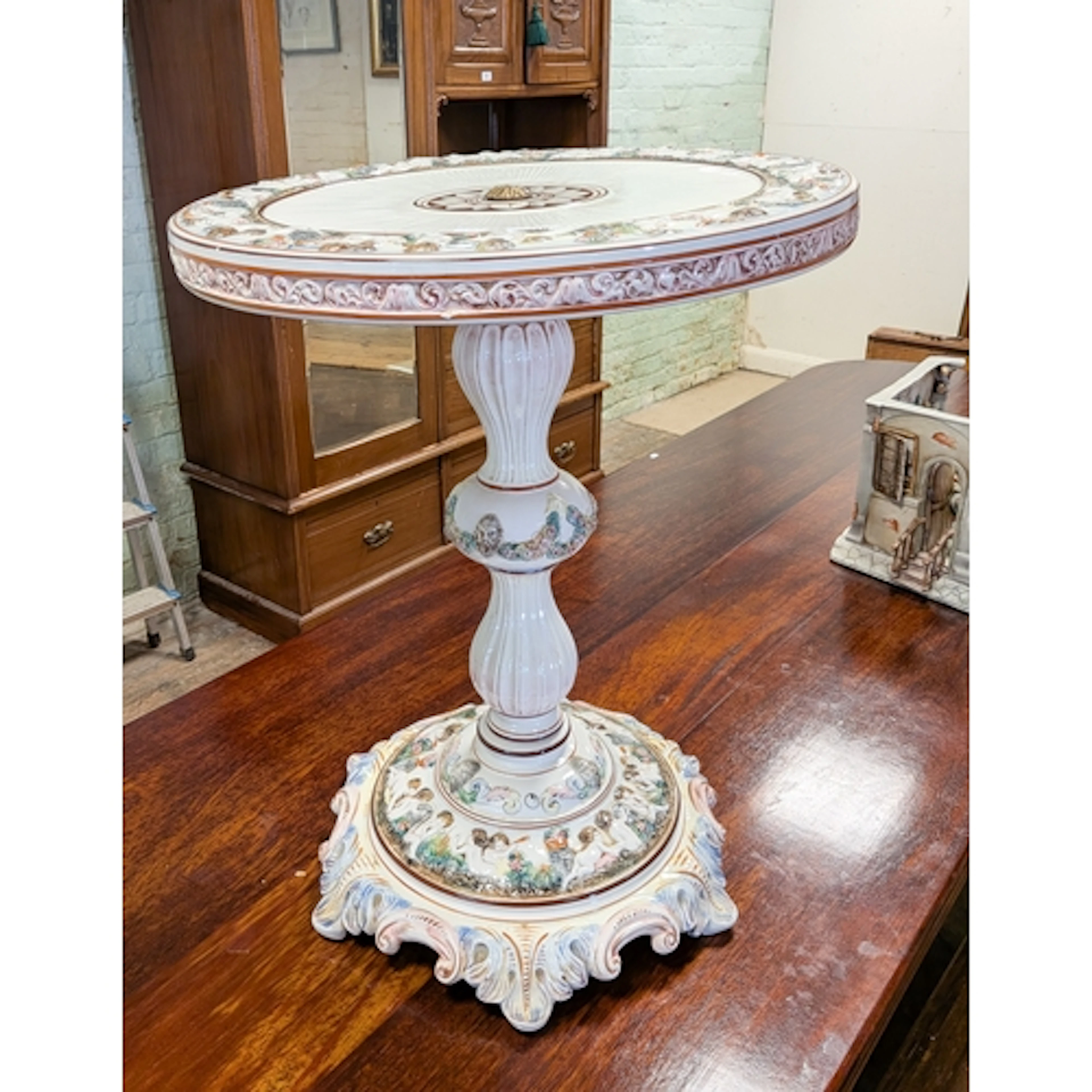 A large Capodimonte occasional table standing on a a pillar ...
