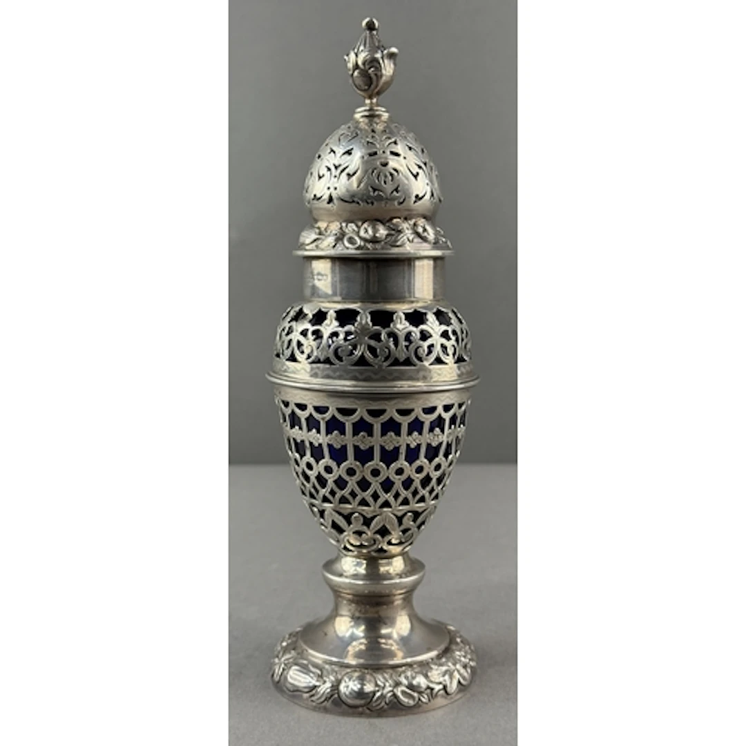 Silver: an ornate pierced sugar caster by Nathan and Hayes, ...