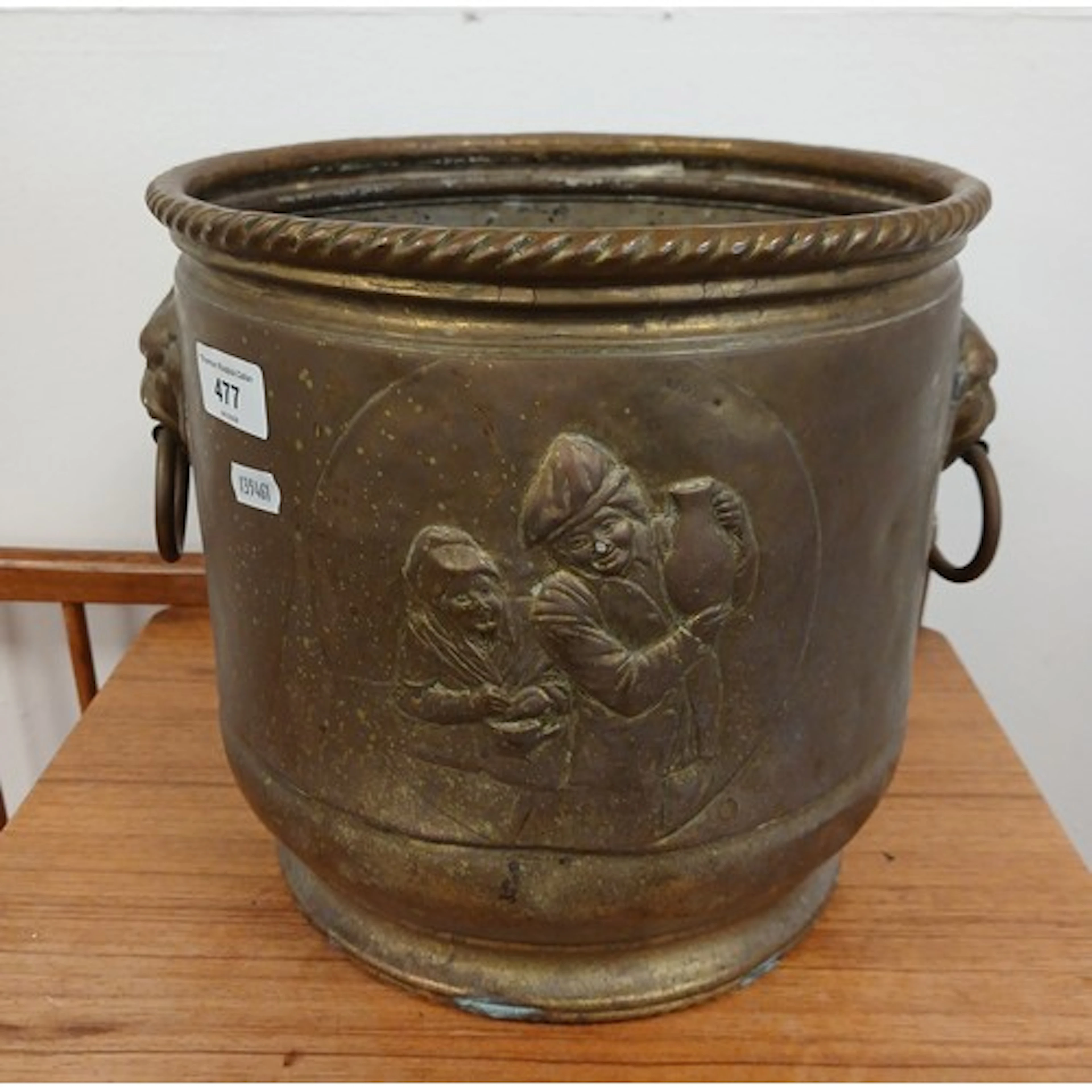 Brass jardiniere with lion mask and ring handles, 27cm H.
