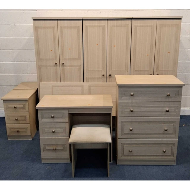 A MODERN OAK EFFECT TEN PIECE BEDROOM SUITE, comprising thre...