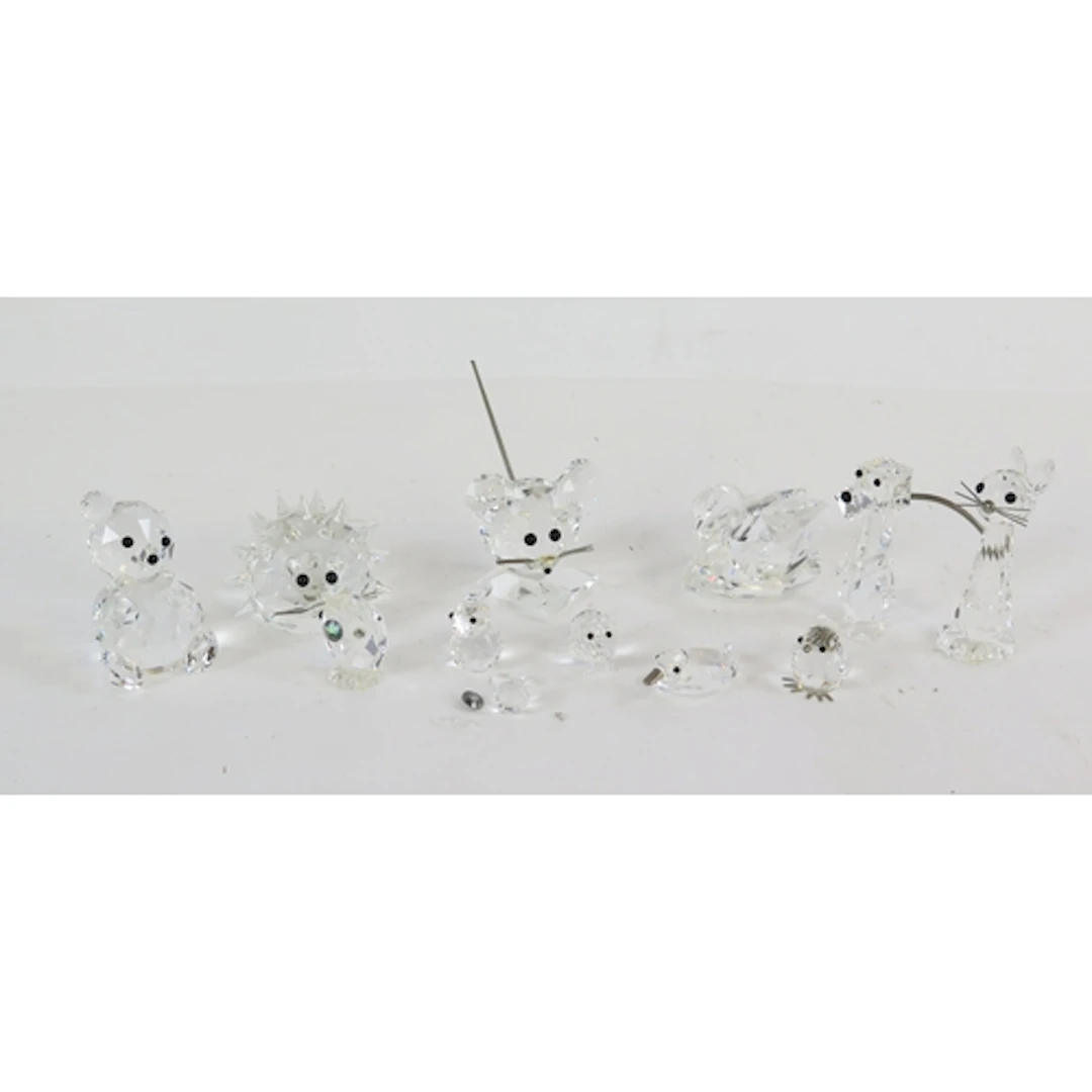 A collection of Swarovski crystal animals including cat, dog...