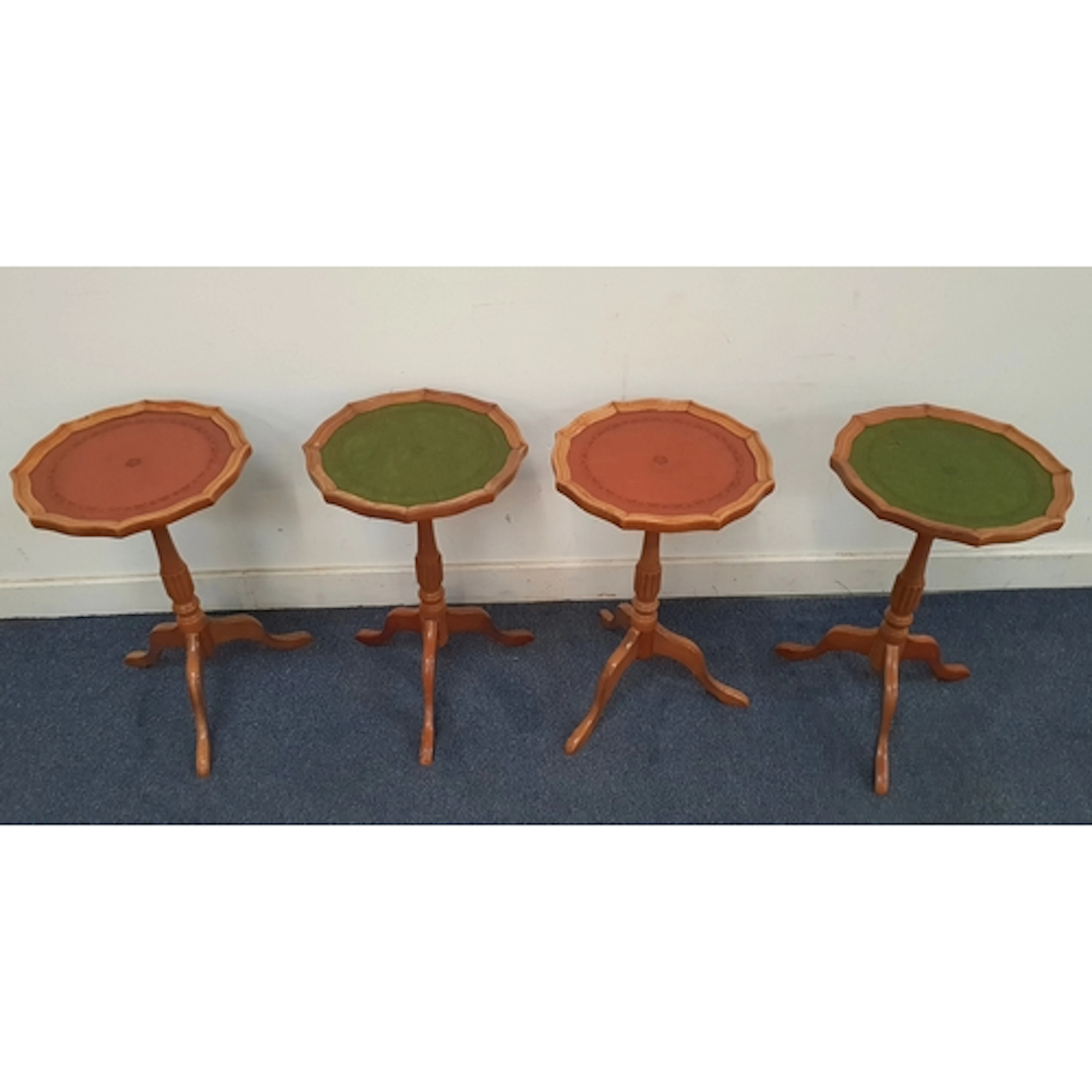 TWO PAIRS OF VINTAGE LEATHER TOPPED WINE TABLES comprising t...