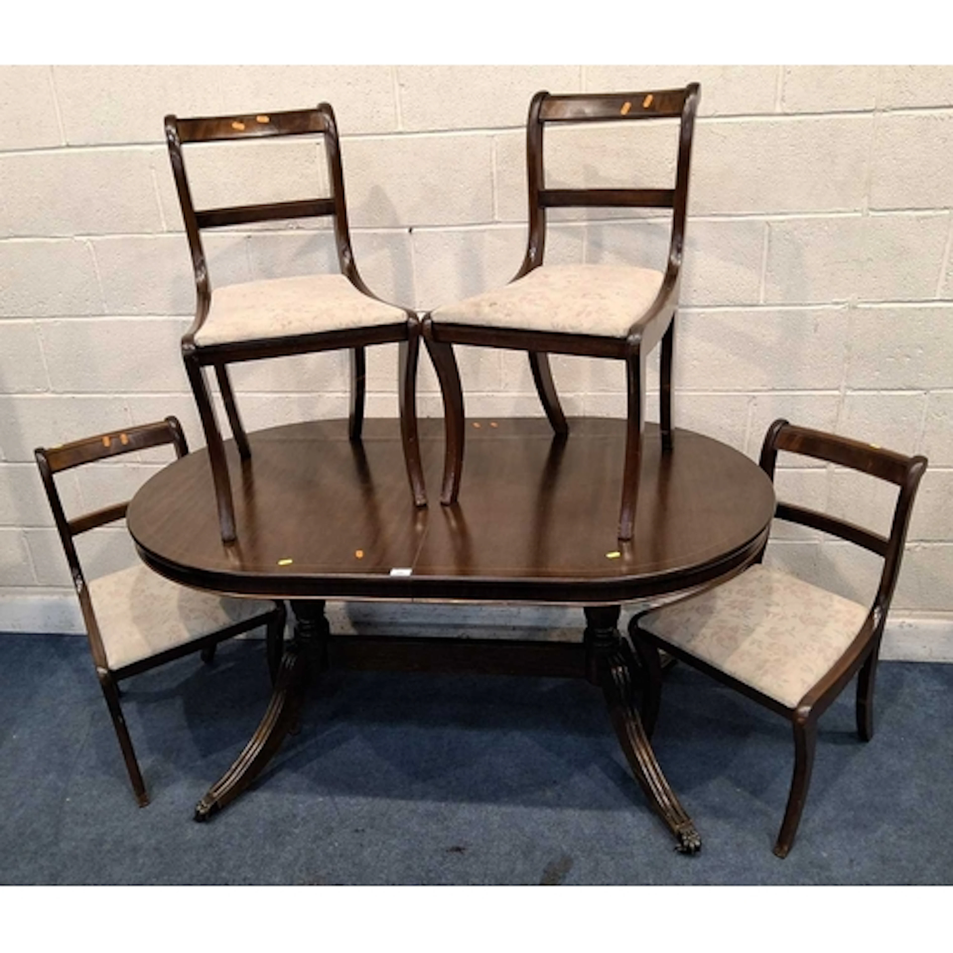 A REPRODUCTION MAHOGANY OVAL EXTENDING DINING TABLE, with on...