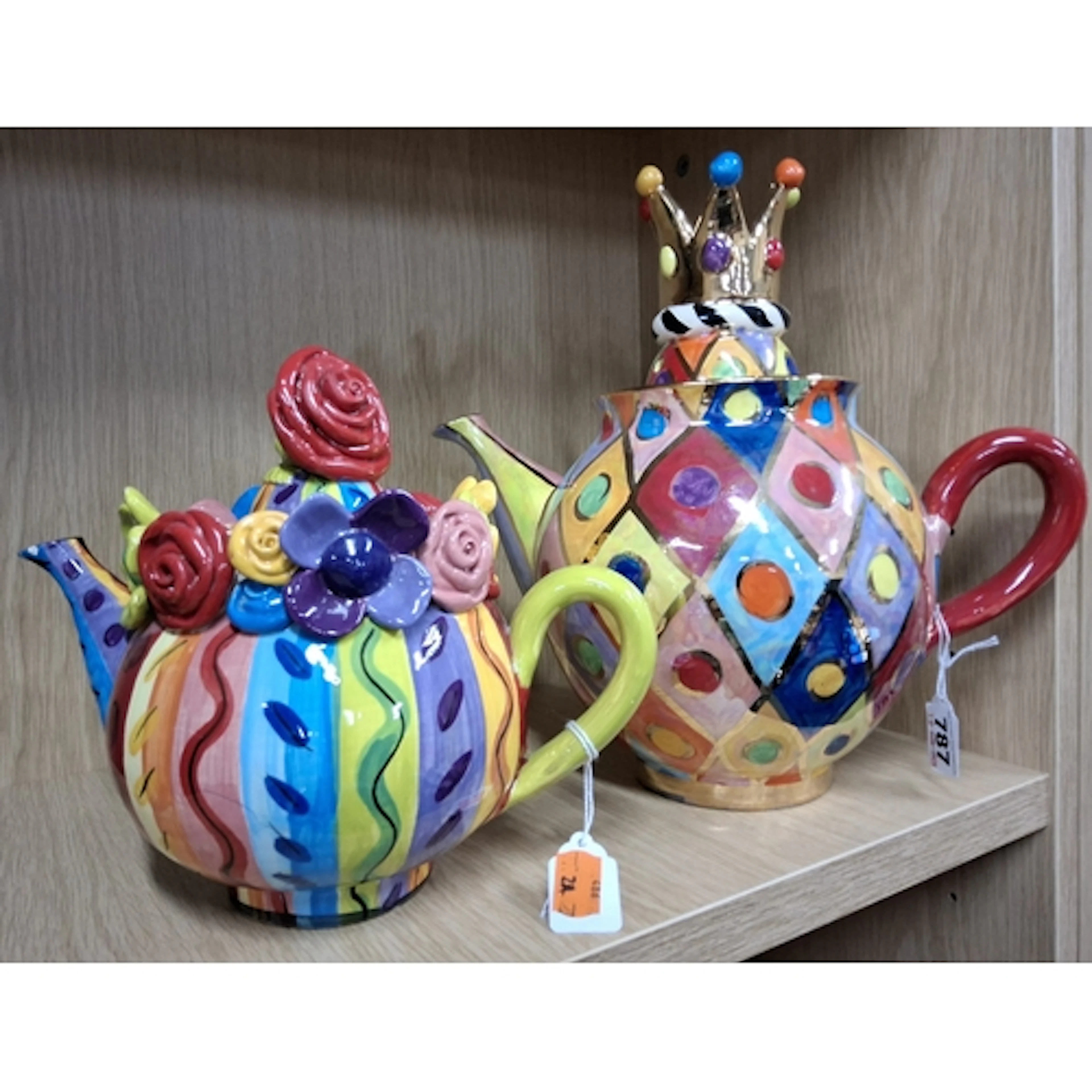 TWO MARY ROSE YOUNG TEAPOTS, the largest painted with bright...