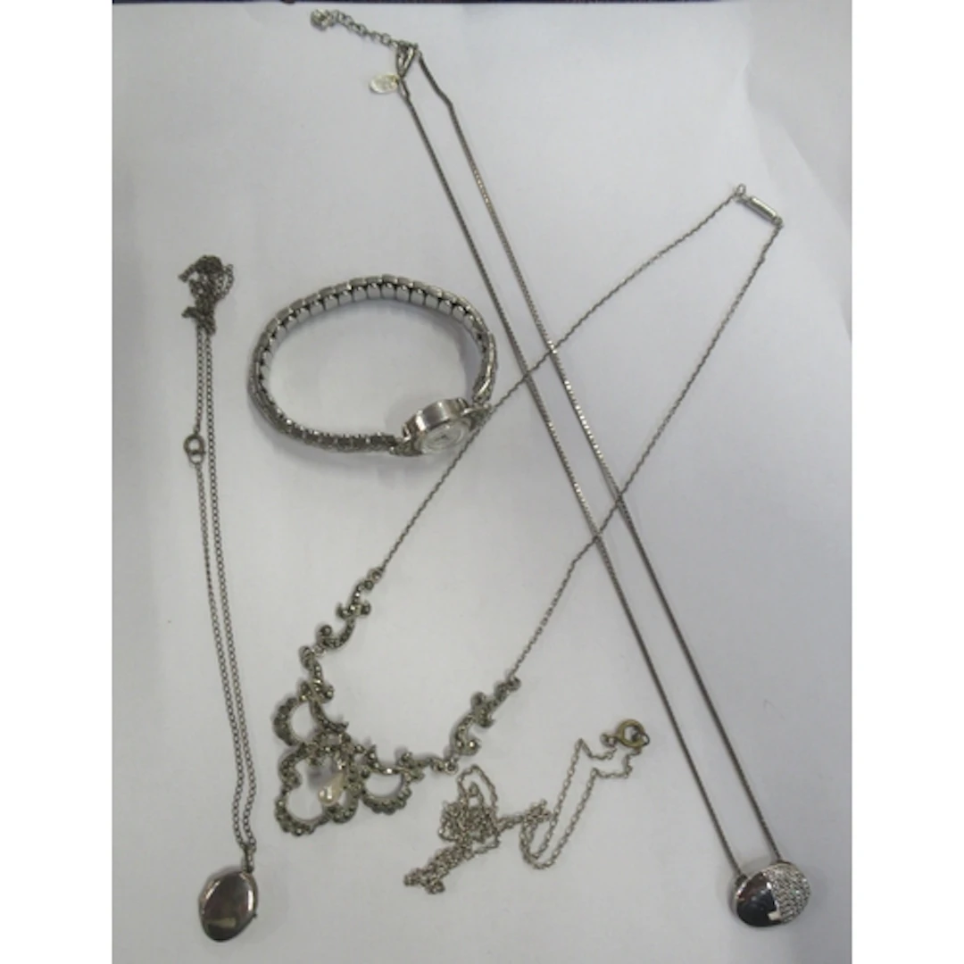 A collection of silver coloured jewellery and a watch