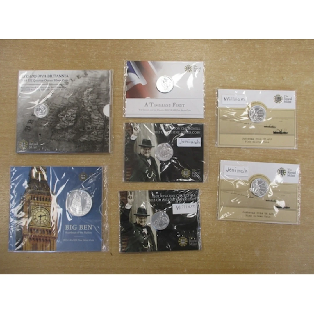 Collection of sealed uncirculated silver packs inset on card...