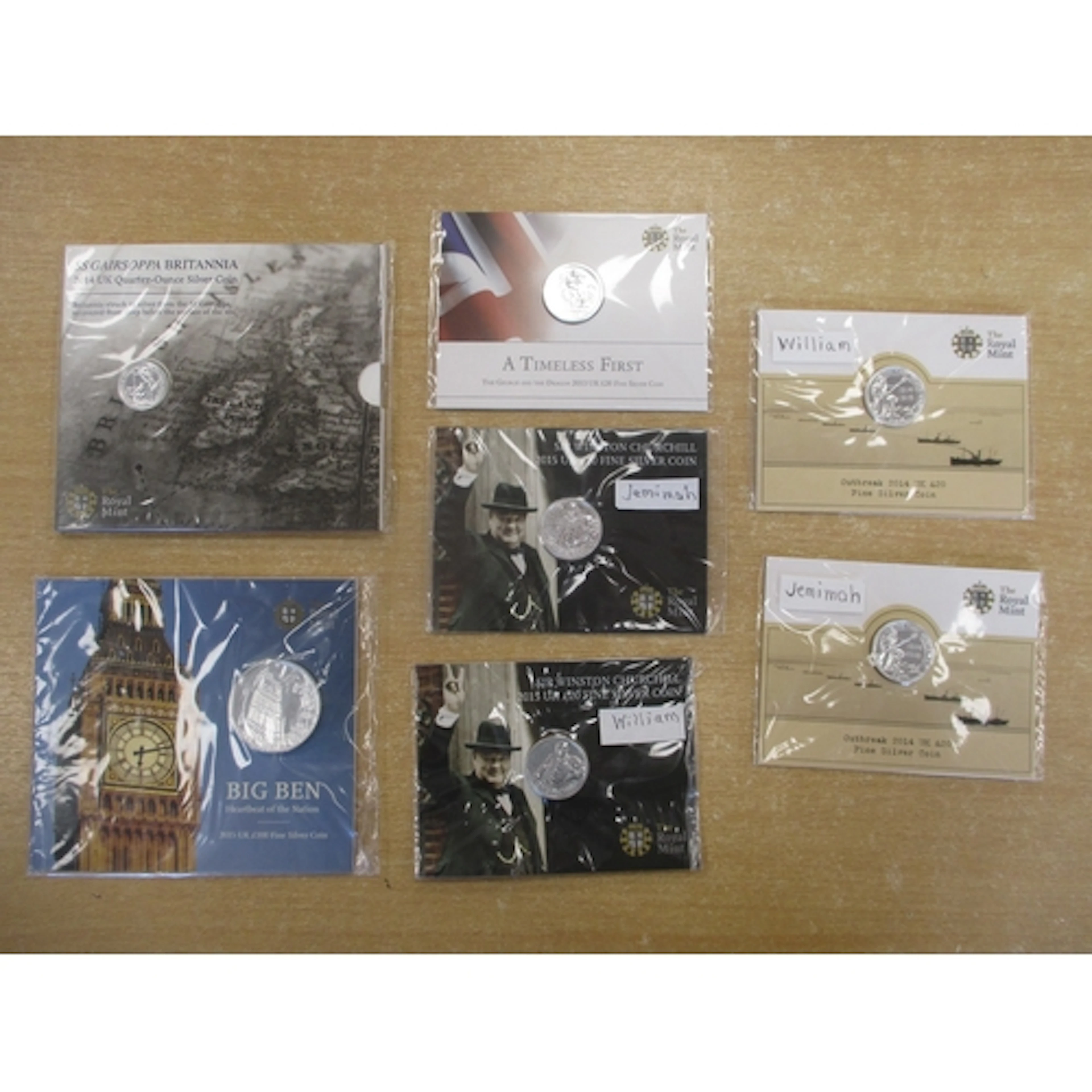 Collection of sealed uncirculated silver packs inset on card...