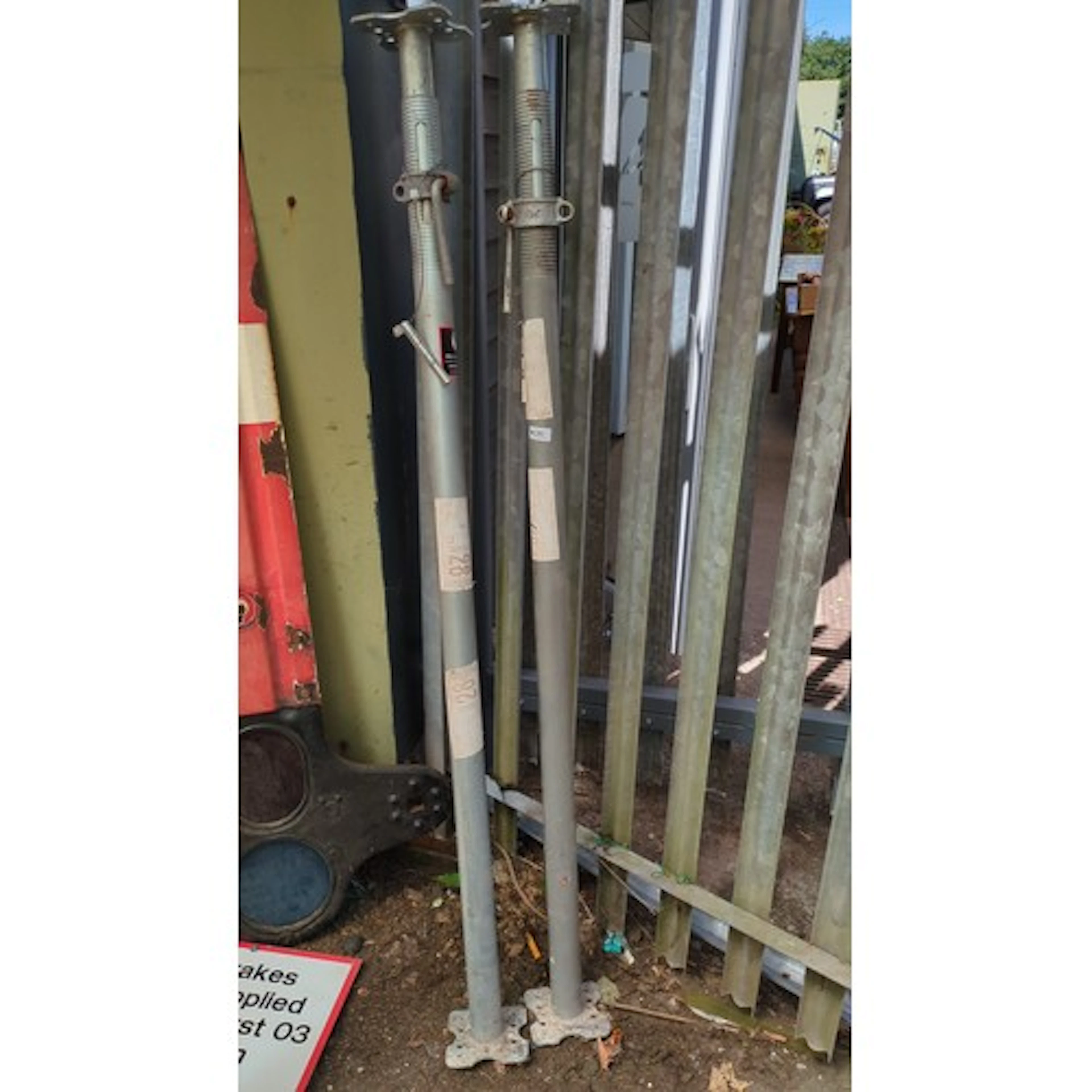 A pair of adjustable steel Acrow props.