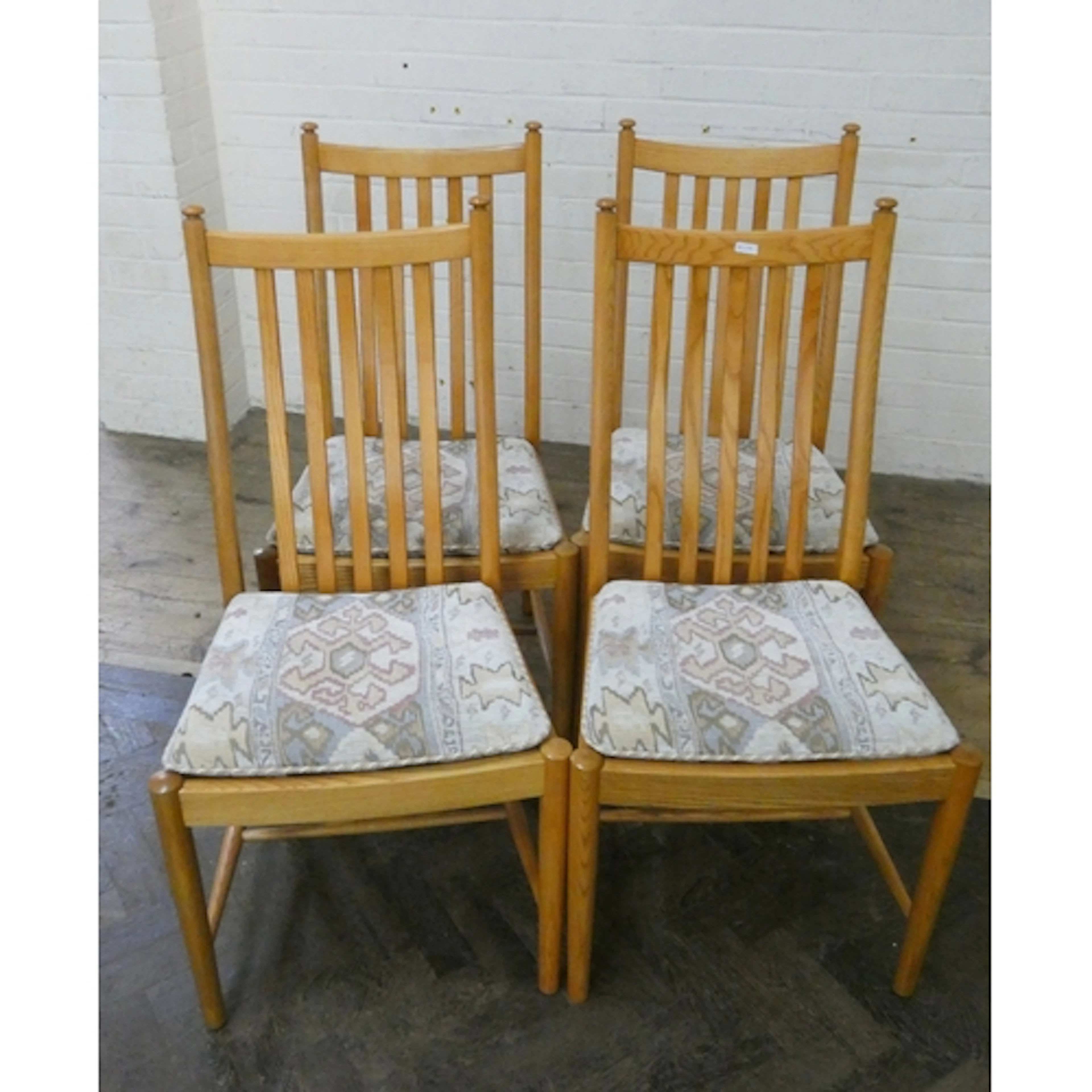 A set of four modern Ercol elm Penn slat backed dining chair...