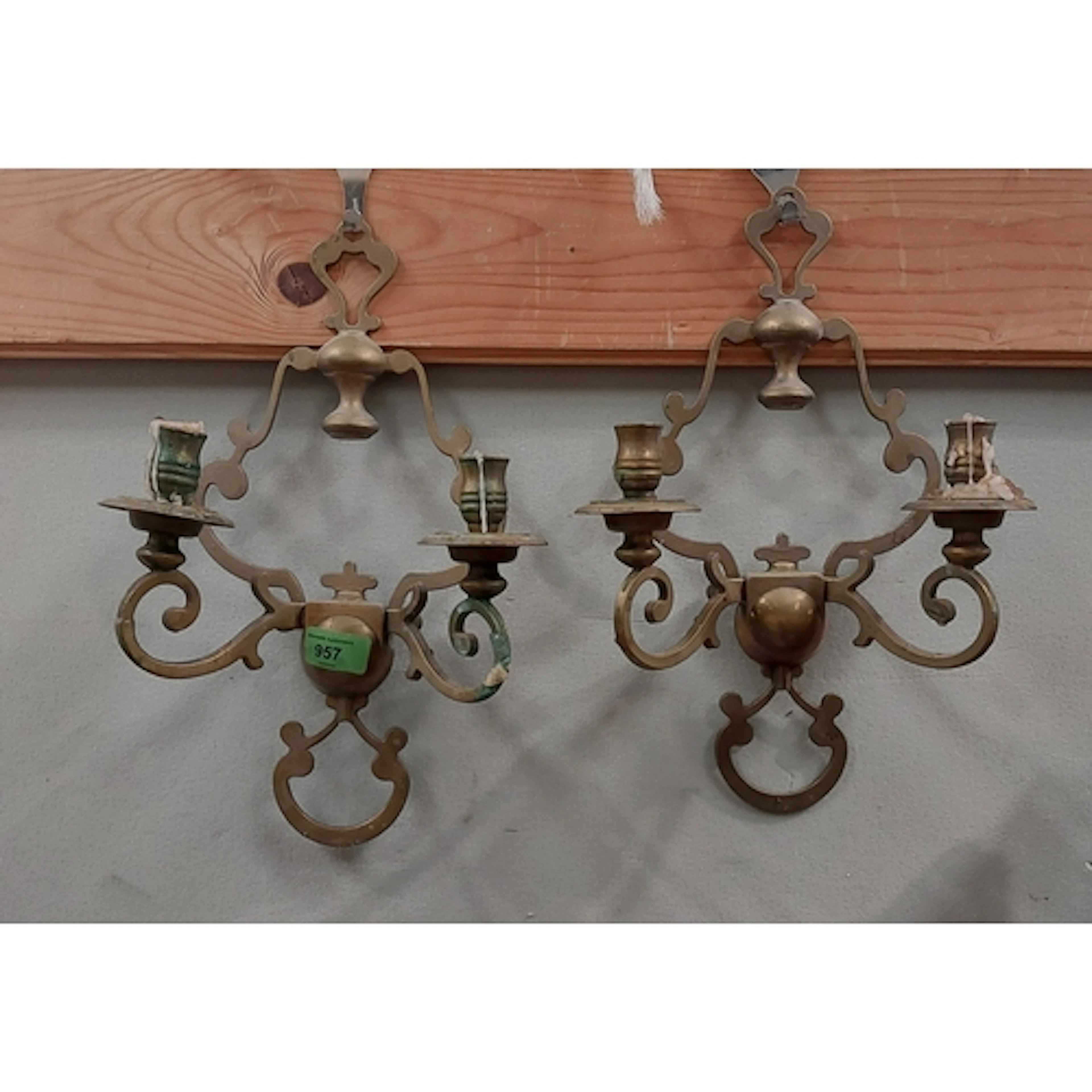 A pair of brass 'Gothic' two branch wall candle sconces