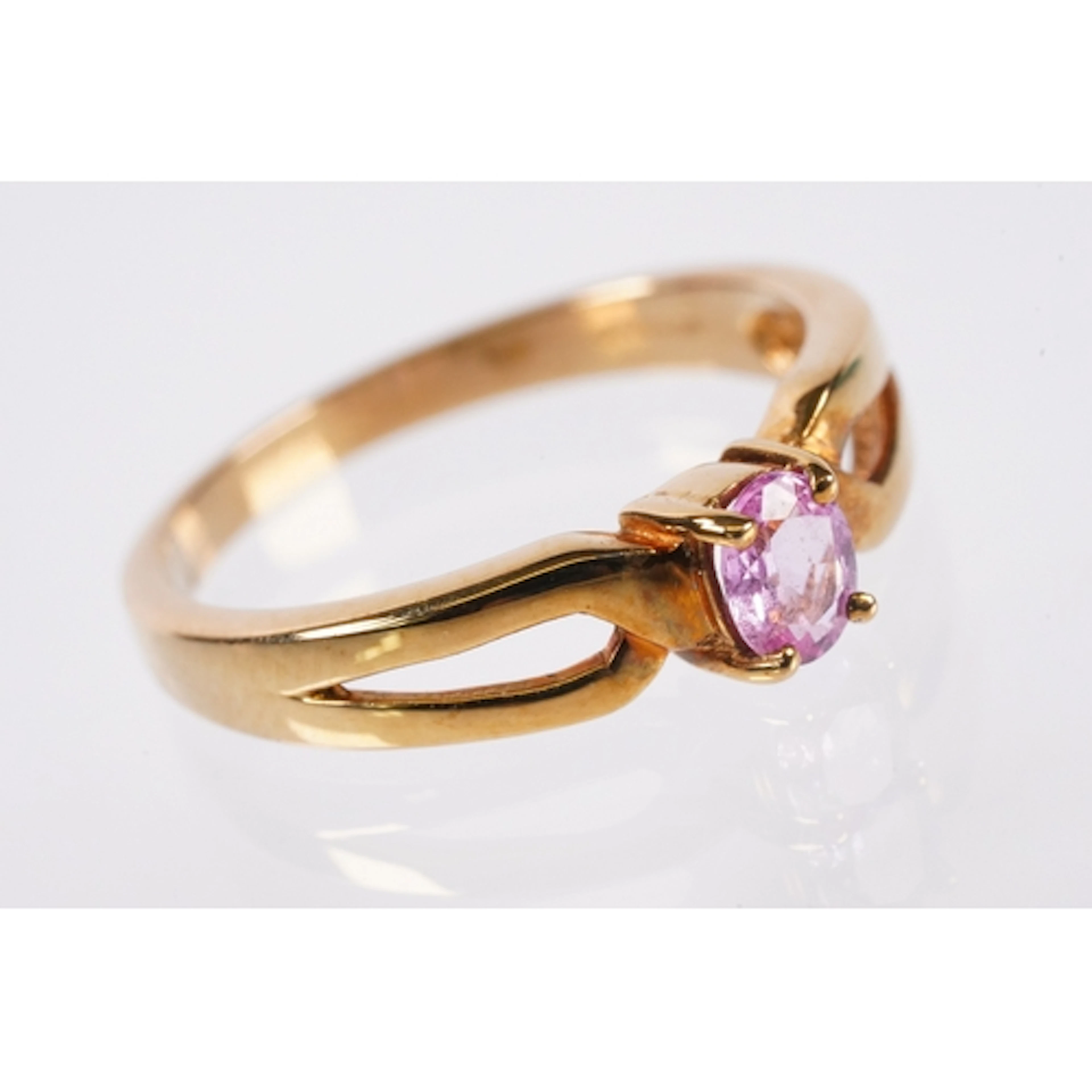 9ct gold and pink sapphire ring. The ring being set with an ...