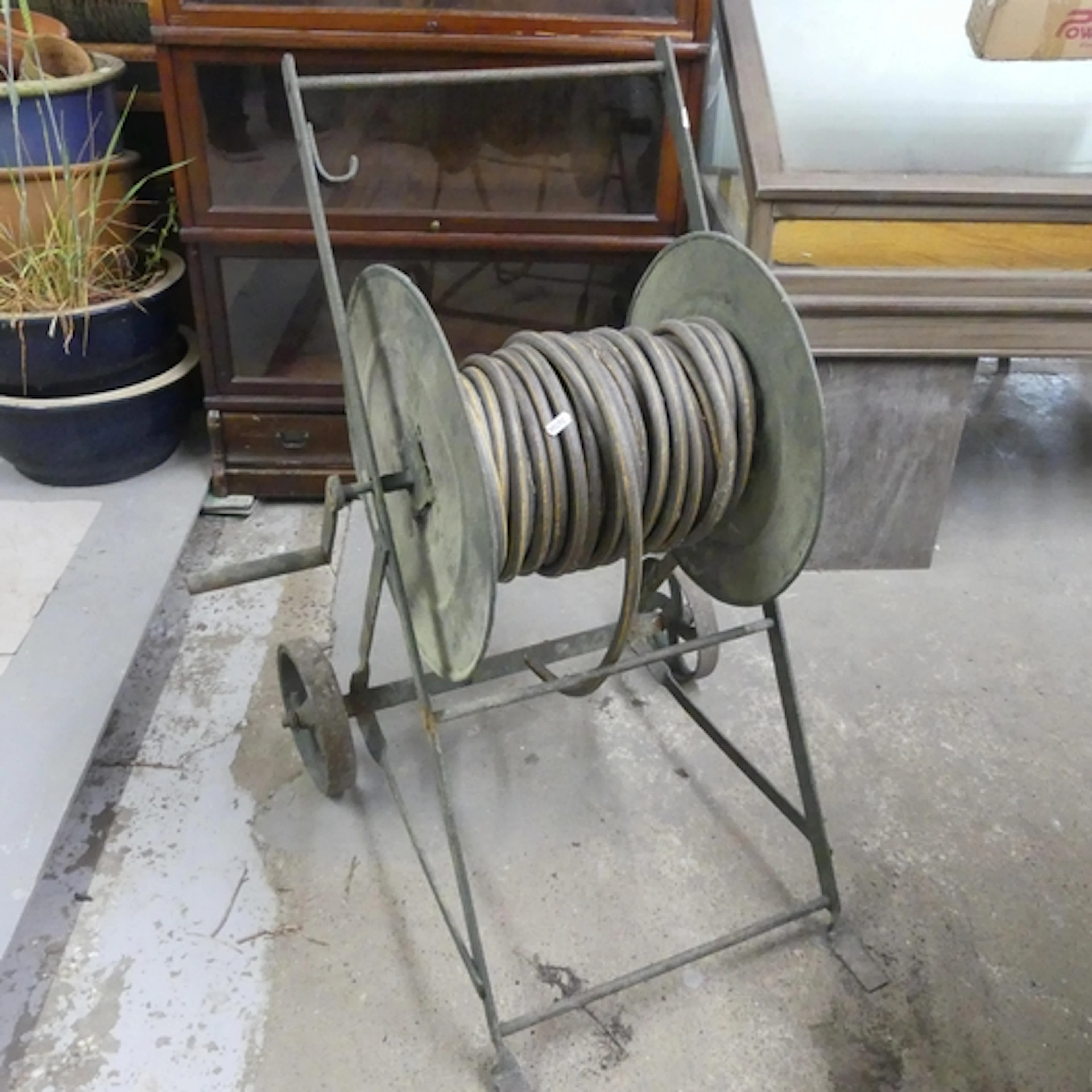 A vintage garden Victorian hose reel. Height 90cm.