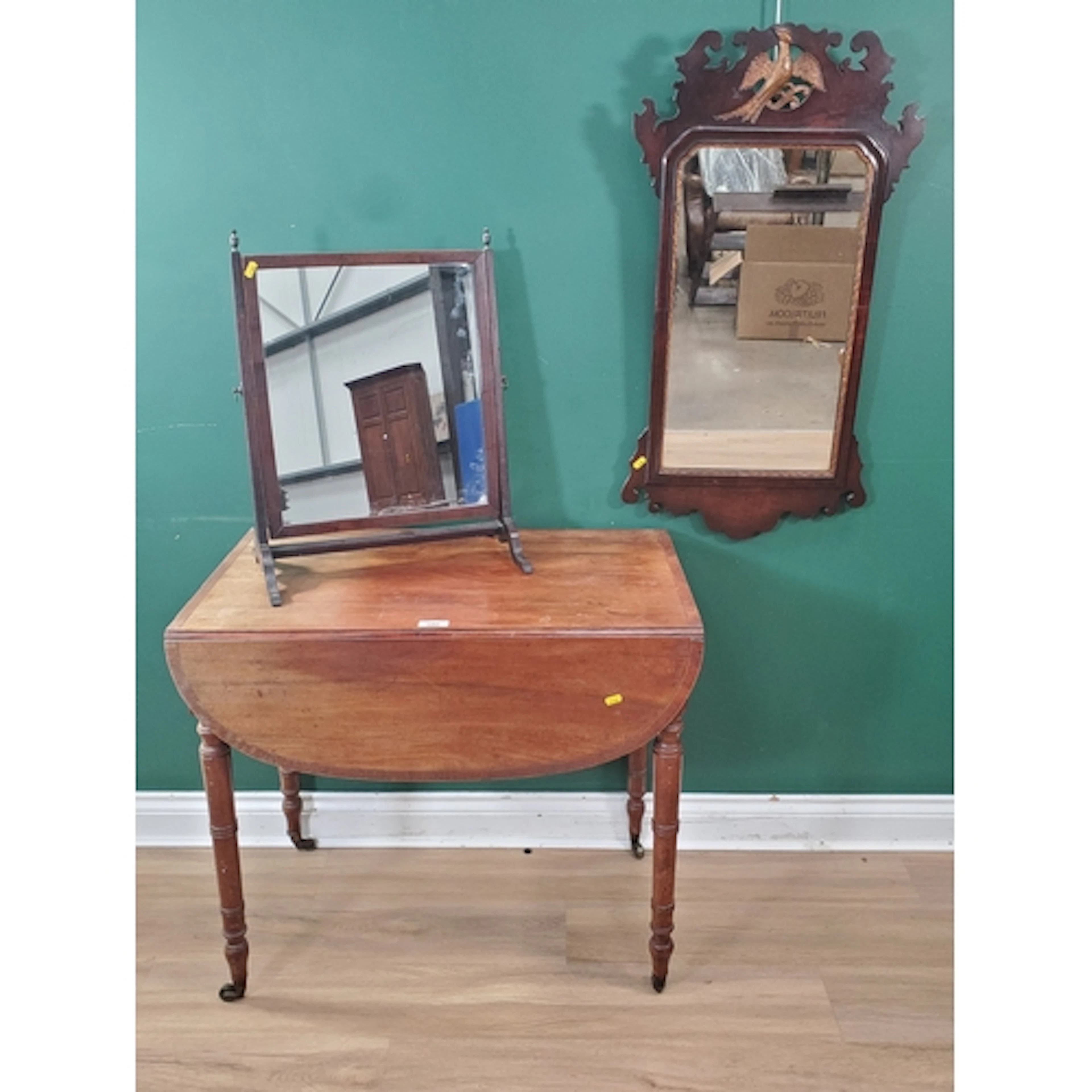 A mahogany Pembroke Table raised on turned supports and cast...