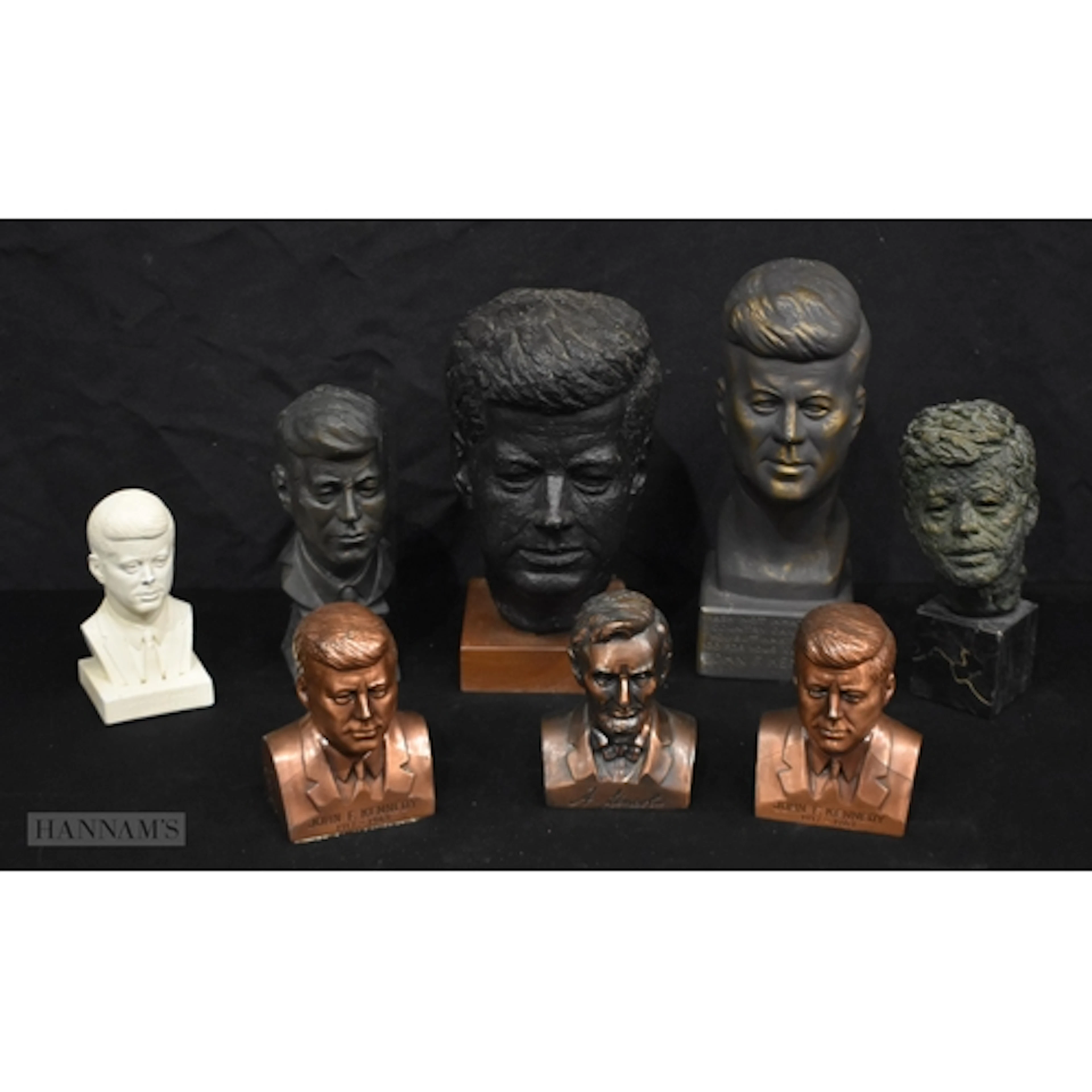 A bronze bust of John F Kennedy together with other busts an...