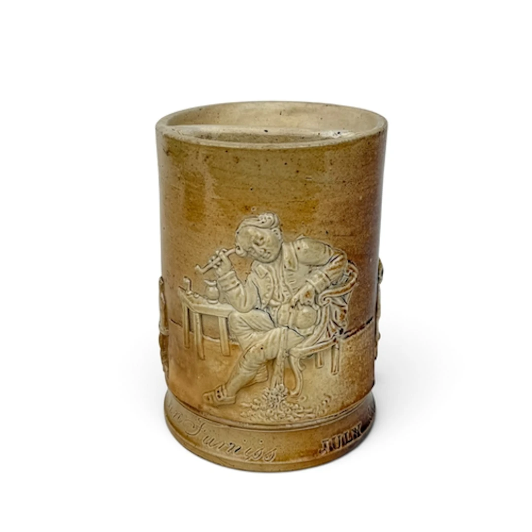 A VICTORIAN SALT-GLAZED STONEWARE MOUSTACHE CUP, 1849 The bo...