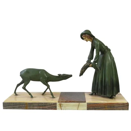 AN ART DECO PAINTED SPELTER GROUP CIRCA 1930 depicting a wom...