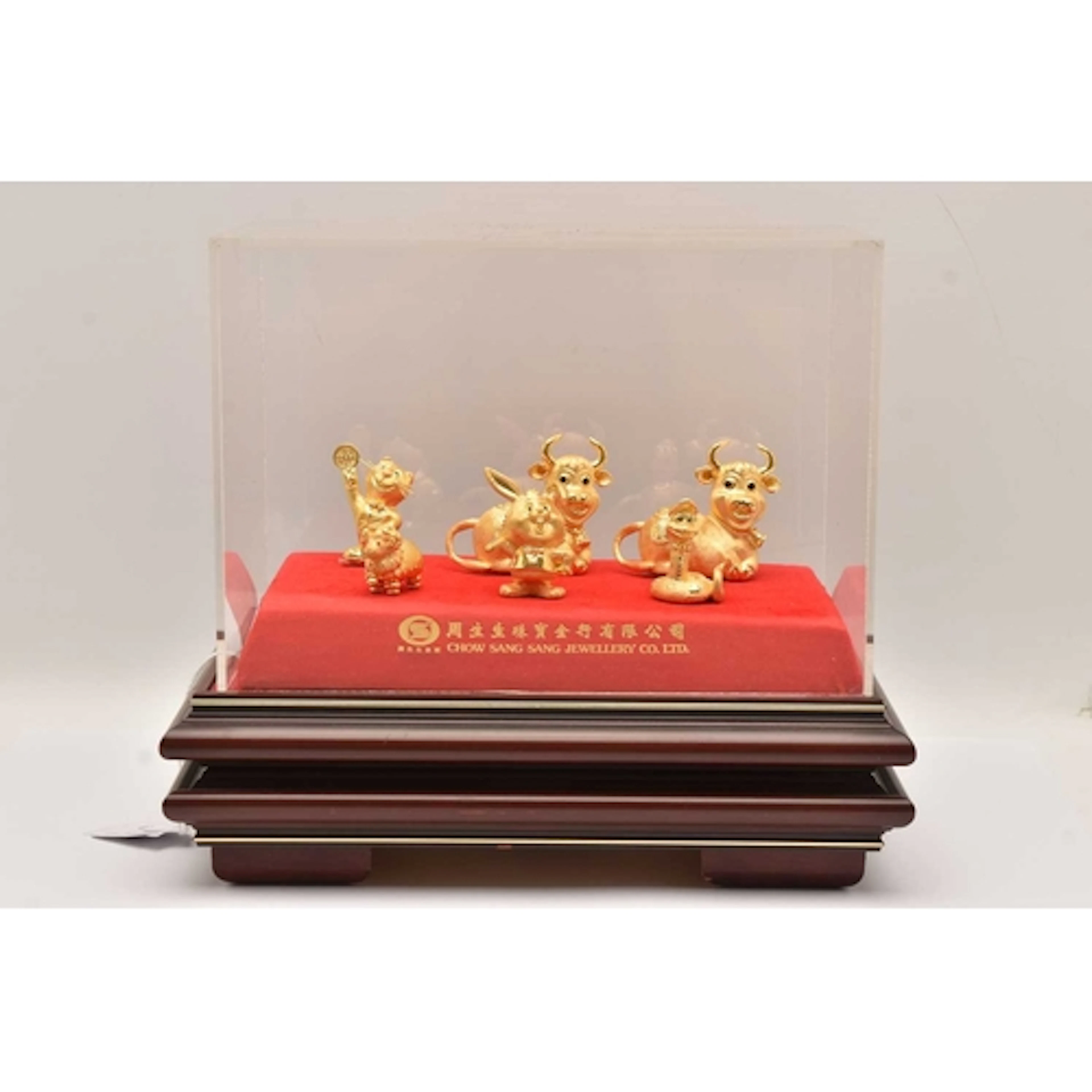 A DISPLAY CASE OF GOLD NOVELTY CHINESE NEW YEAR FIGURES, a w...