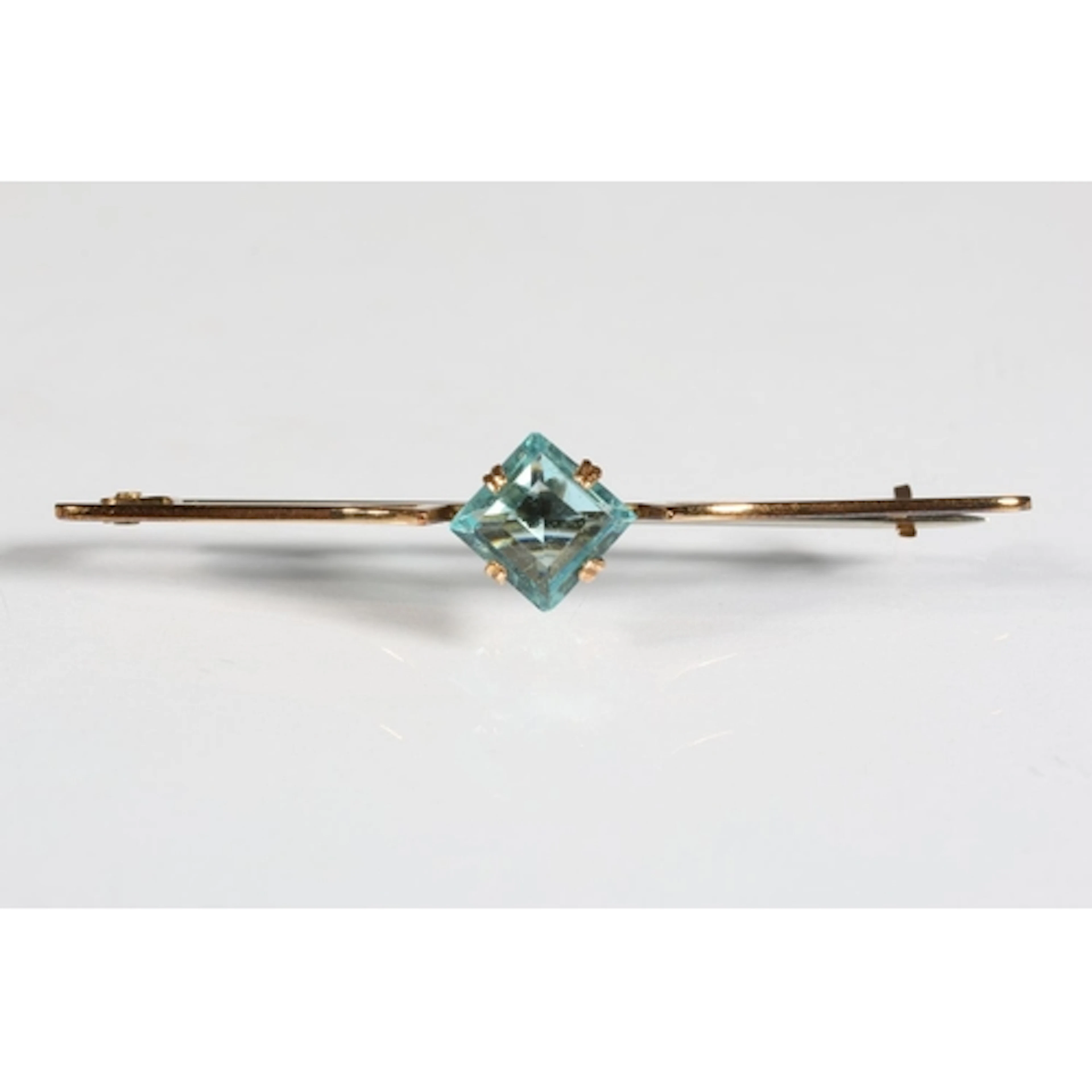 9ct gold bar brooch set with aquamarine coloured pale blue s...