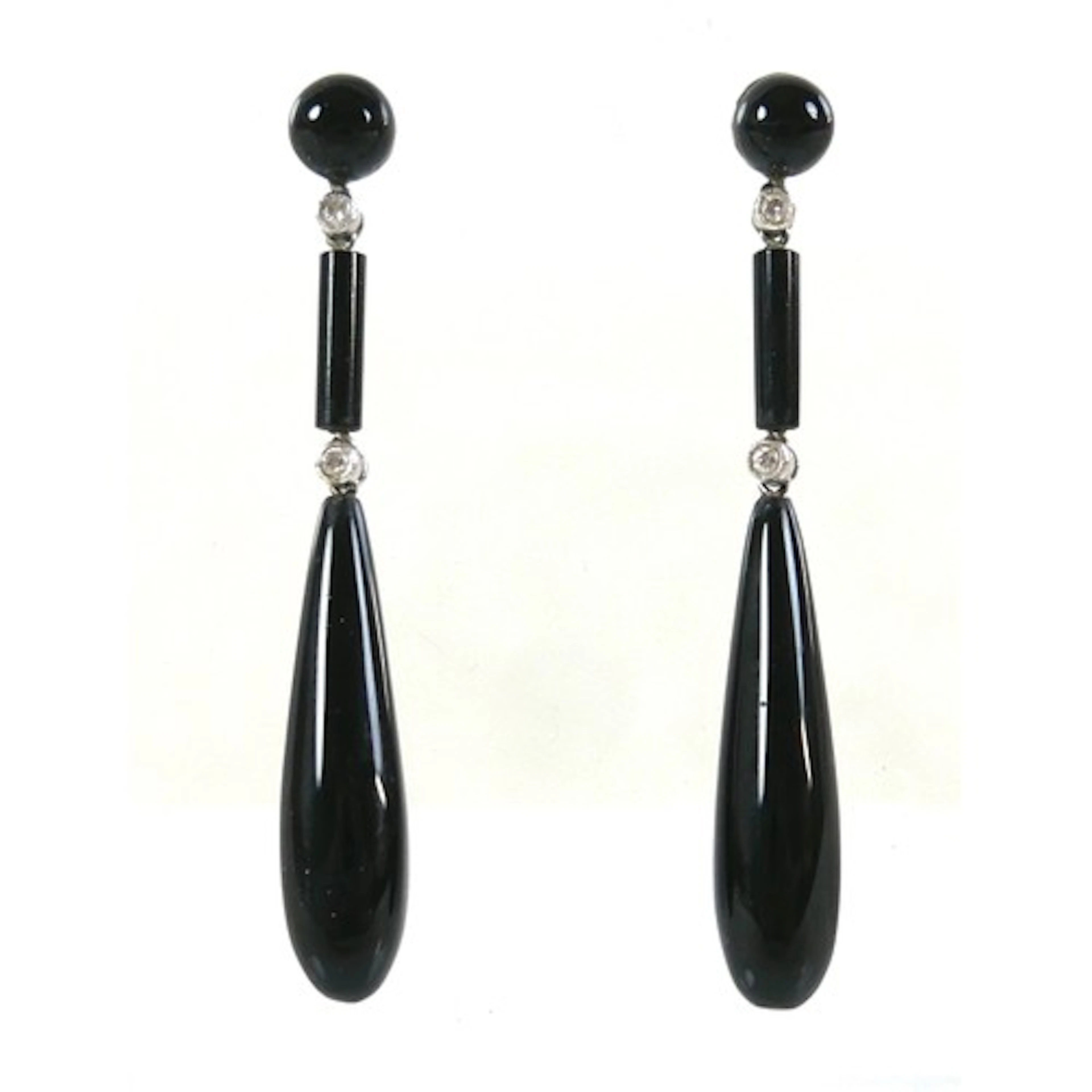 A pair of white metal, black onyx, and diamond set pendant d...