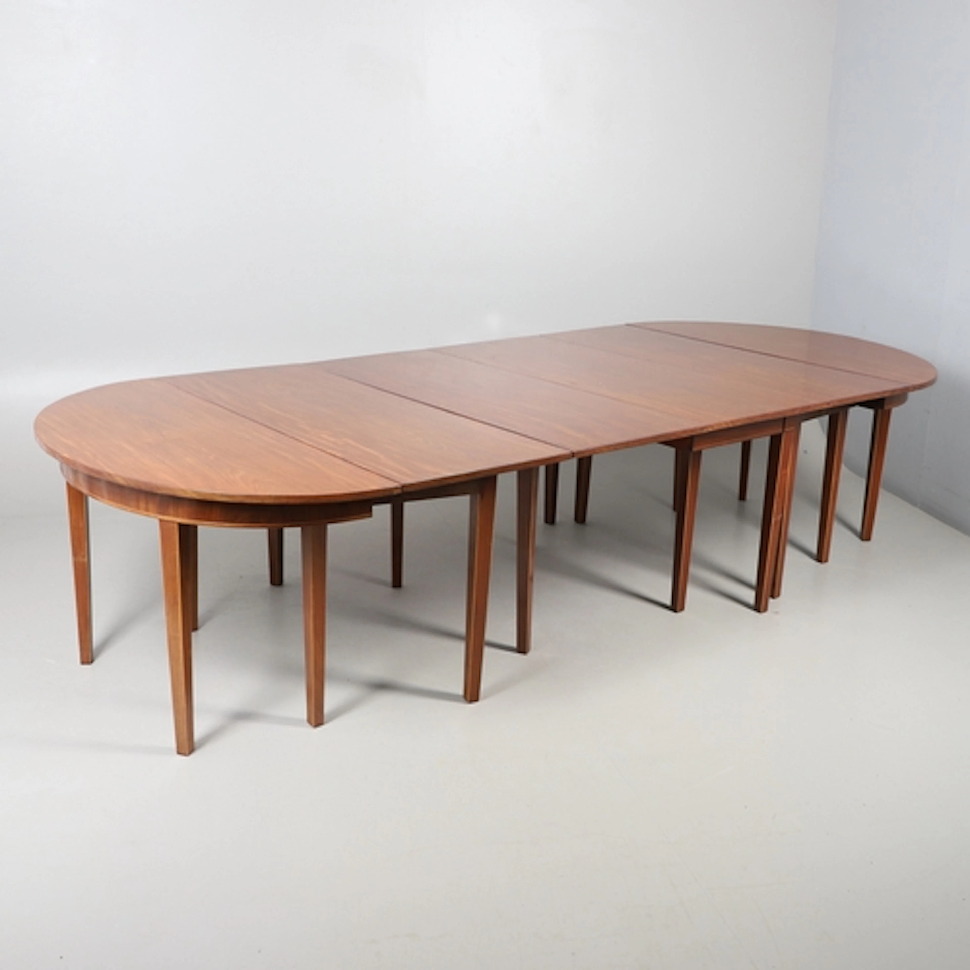 A MAHOGANY EXTENDING DINING TABLE OF GEORGE III DESIGN. cons...