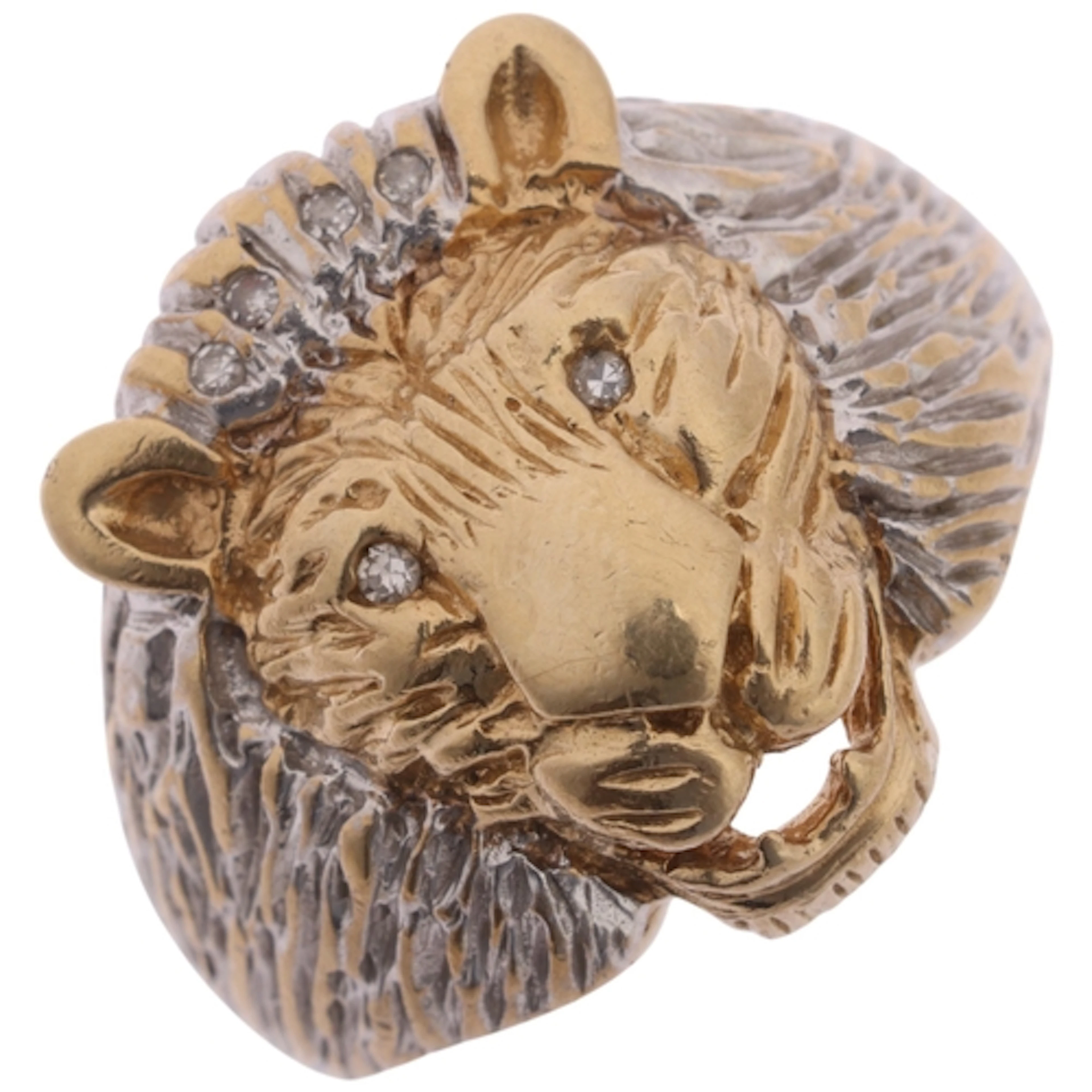 A 9ct two-colour gold diamond lion head ring, maker GA, sett...
