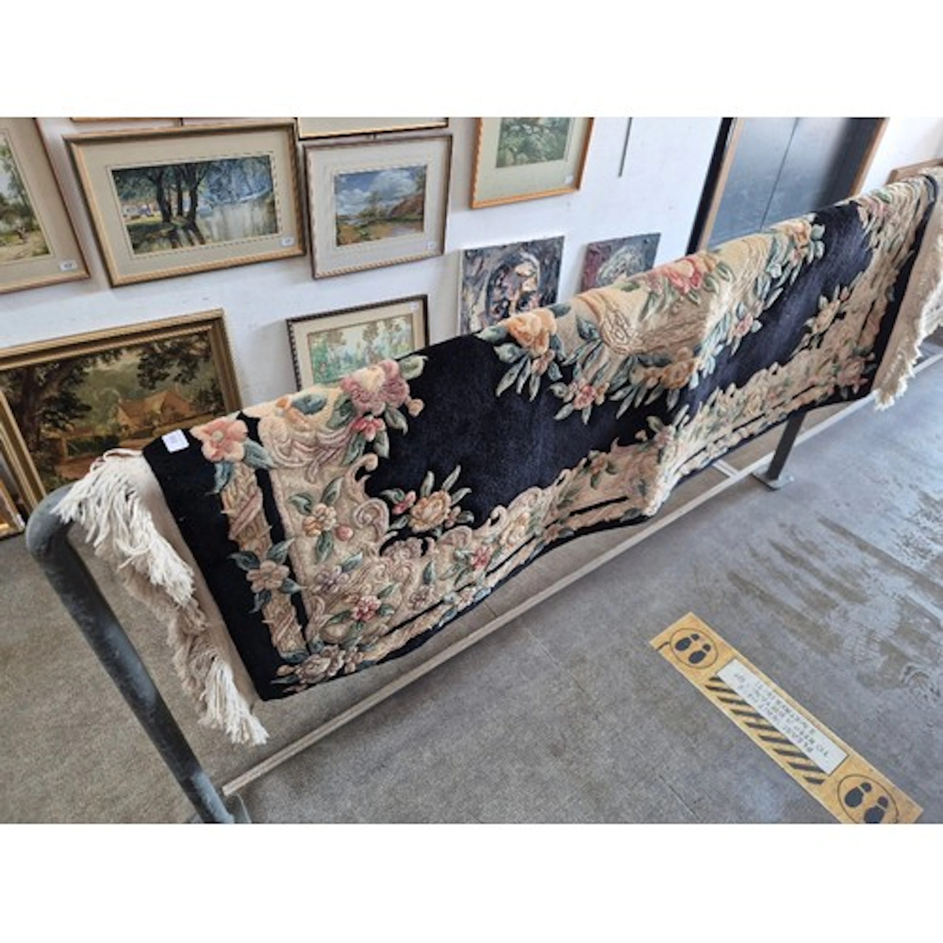 A Chinese wool carpet, black ground, 183cm x 122cm (approx).