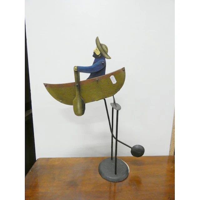 Vintage tinplate swinging toy of a fisherman in a rowing boa...