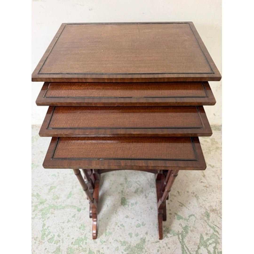 An Edwardian nest of four mahogany tables supported on slend...