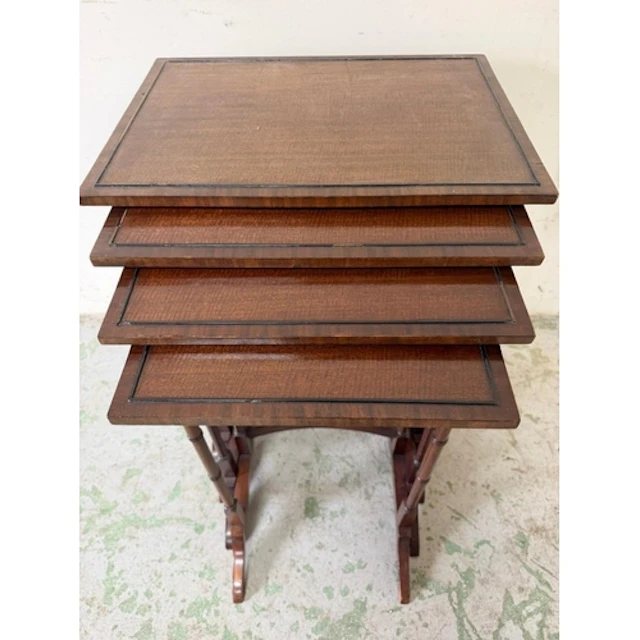 An Edwardian nest of four mahogany tables supported on slend...