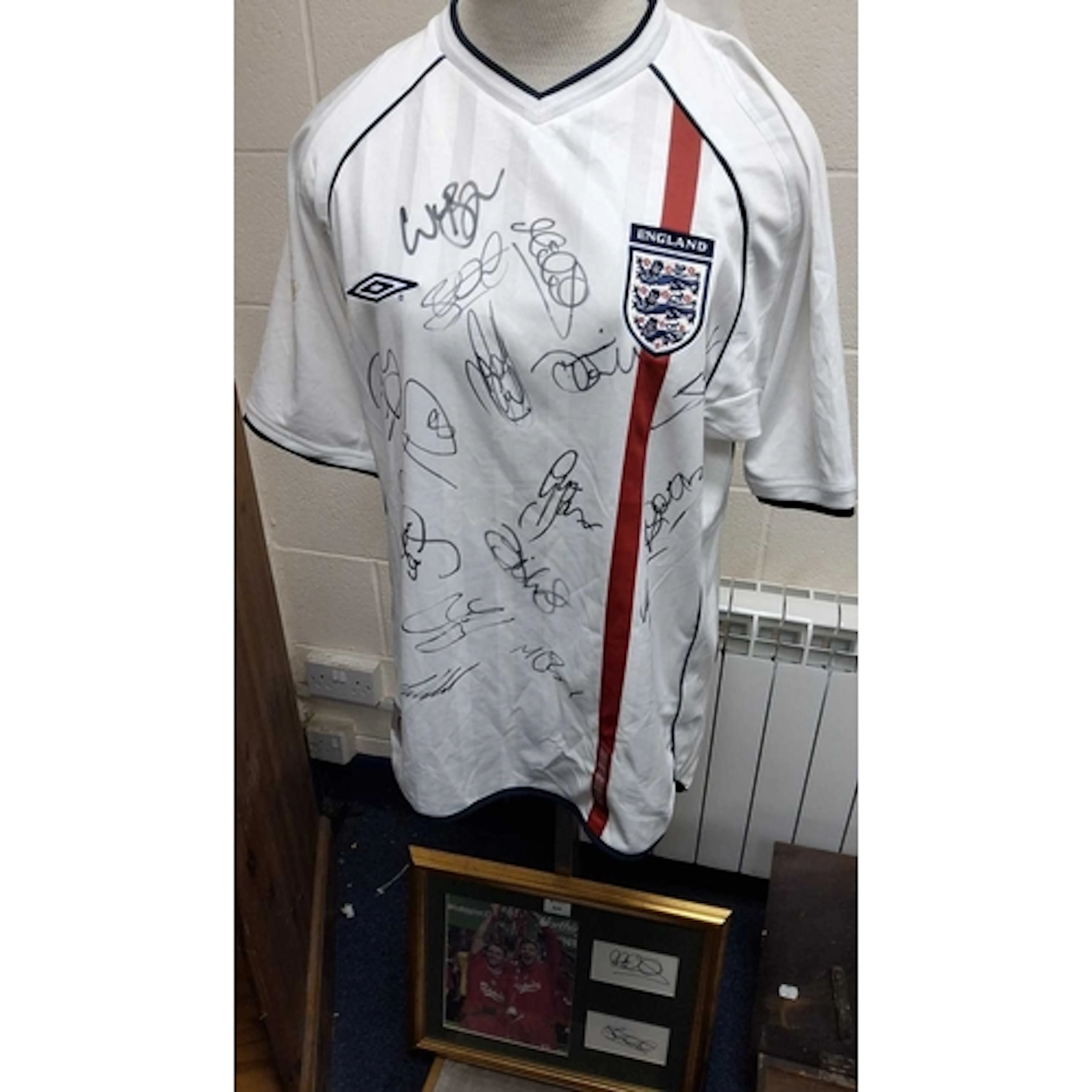 A SIGNED ENGLAND FOOTBALL SHIRT from Umbro, 2002/2003 Season...