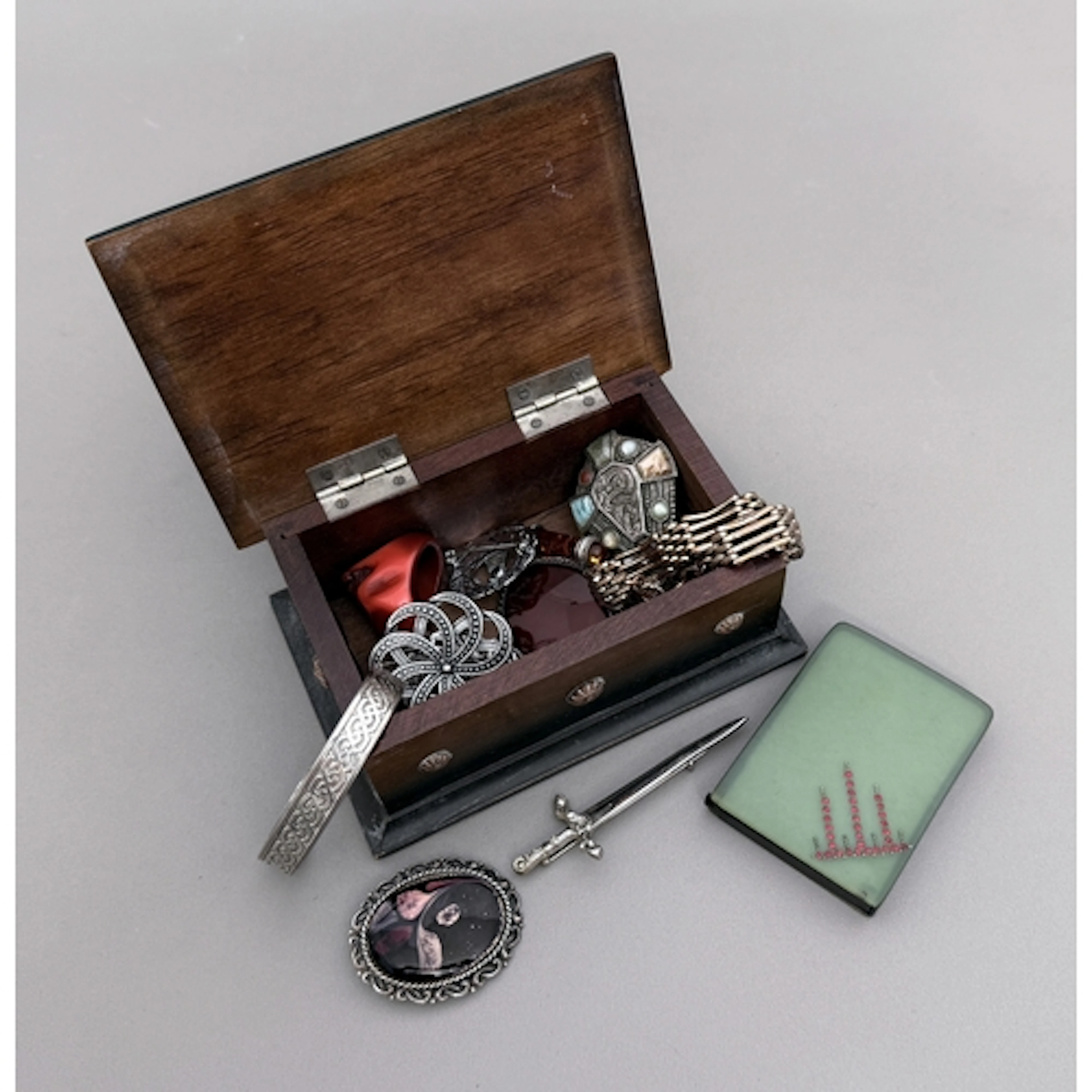 Thirteen pieces of costume jewellery contained in a copper-t...