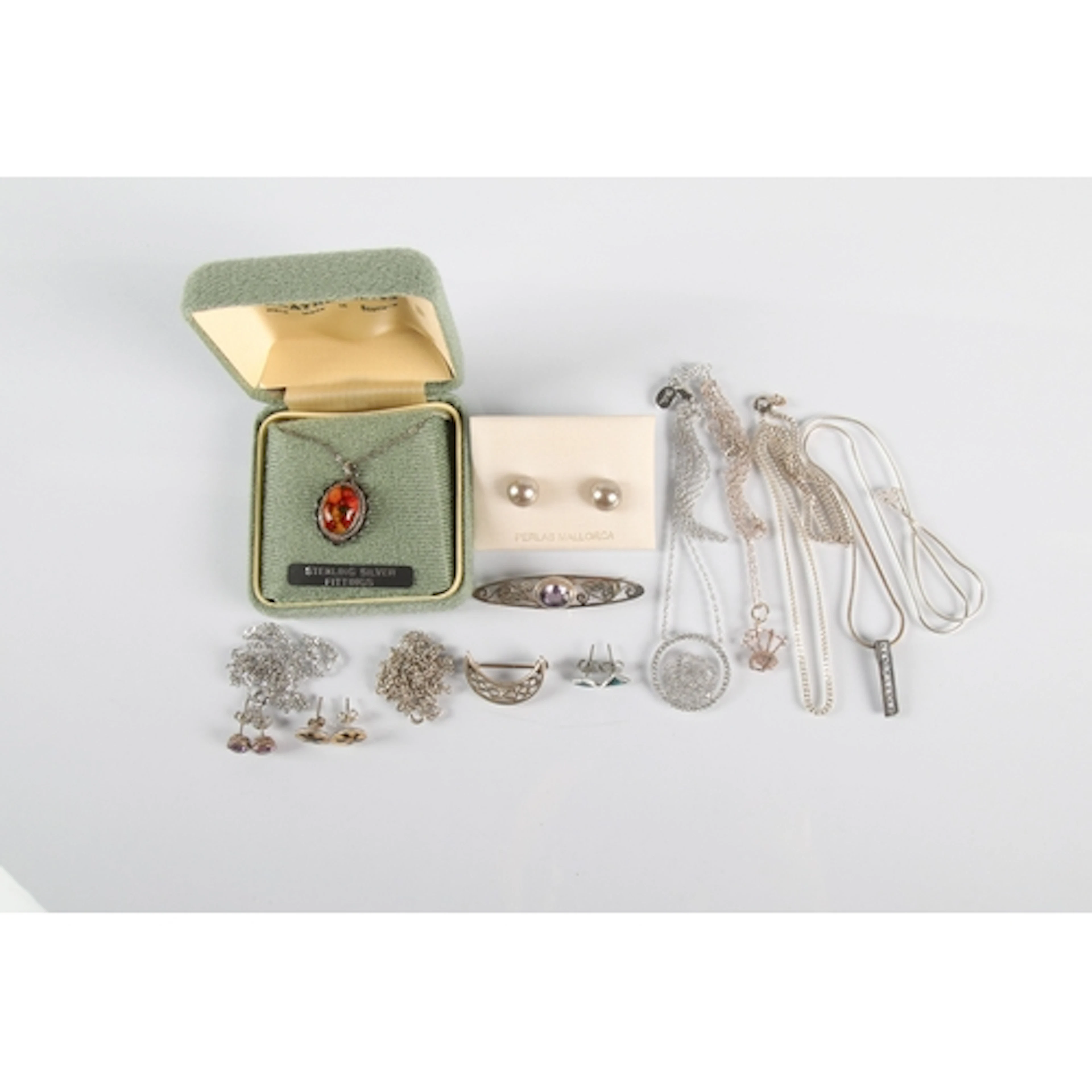 Various chains, pendants, silver brooches etc