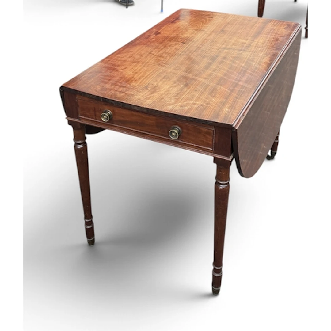 A GEORGIAN MAHOGANY DROP LEAF TABLE Raised on four legs on b...
