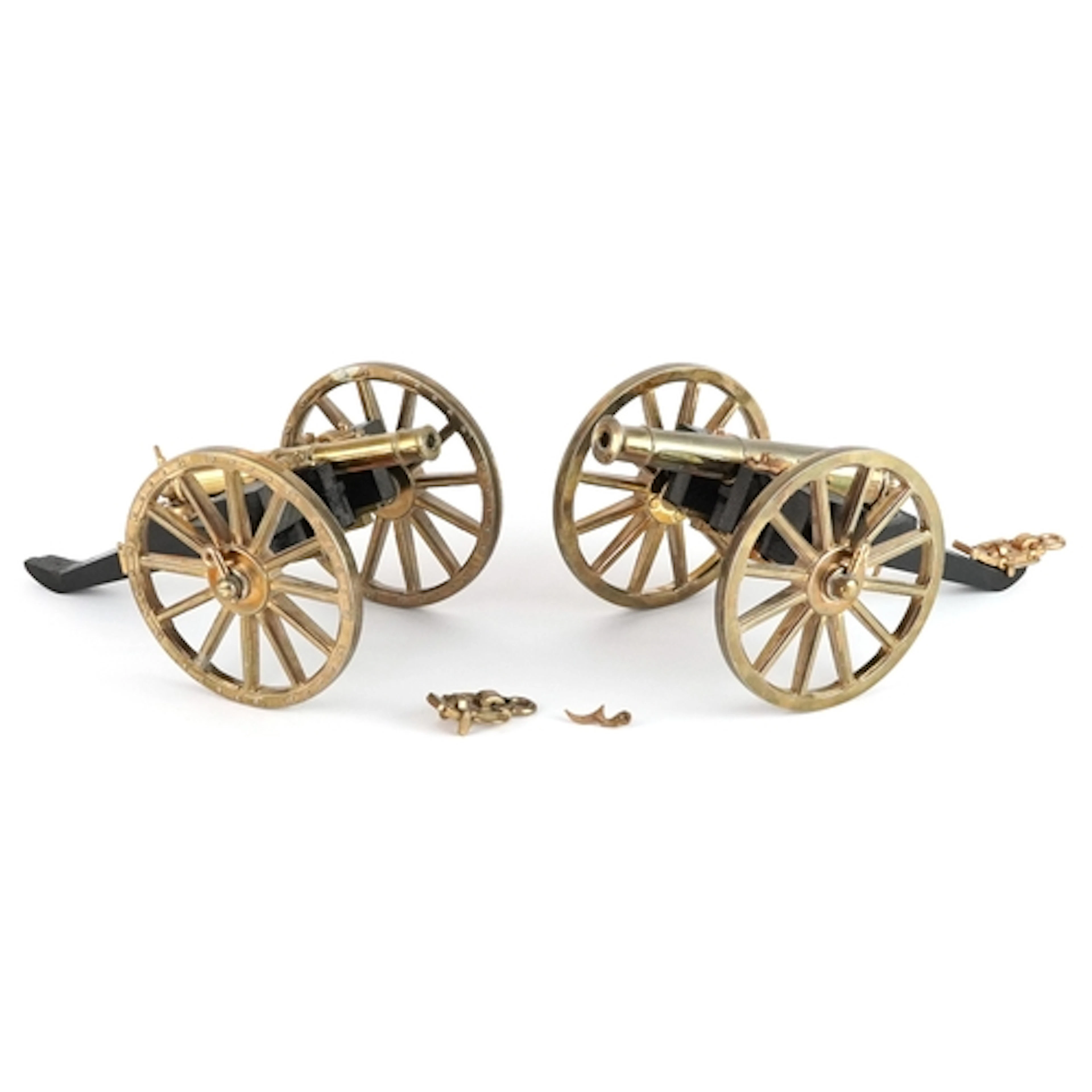 Two vintage brass and wood table cannons, the largest 23cm i...