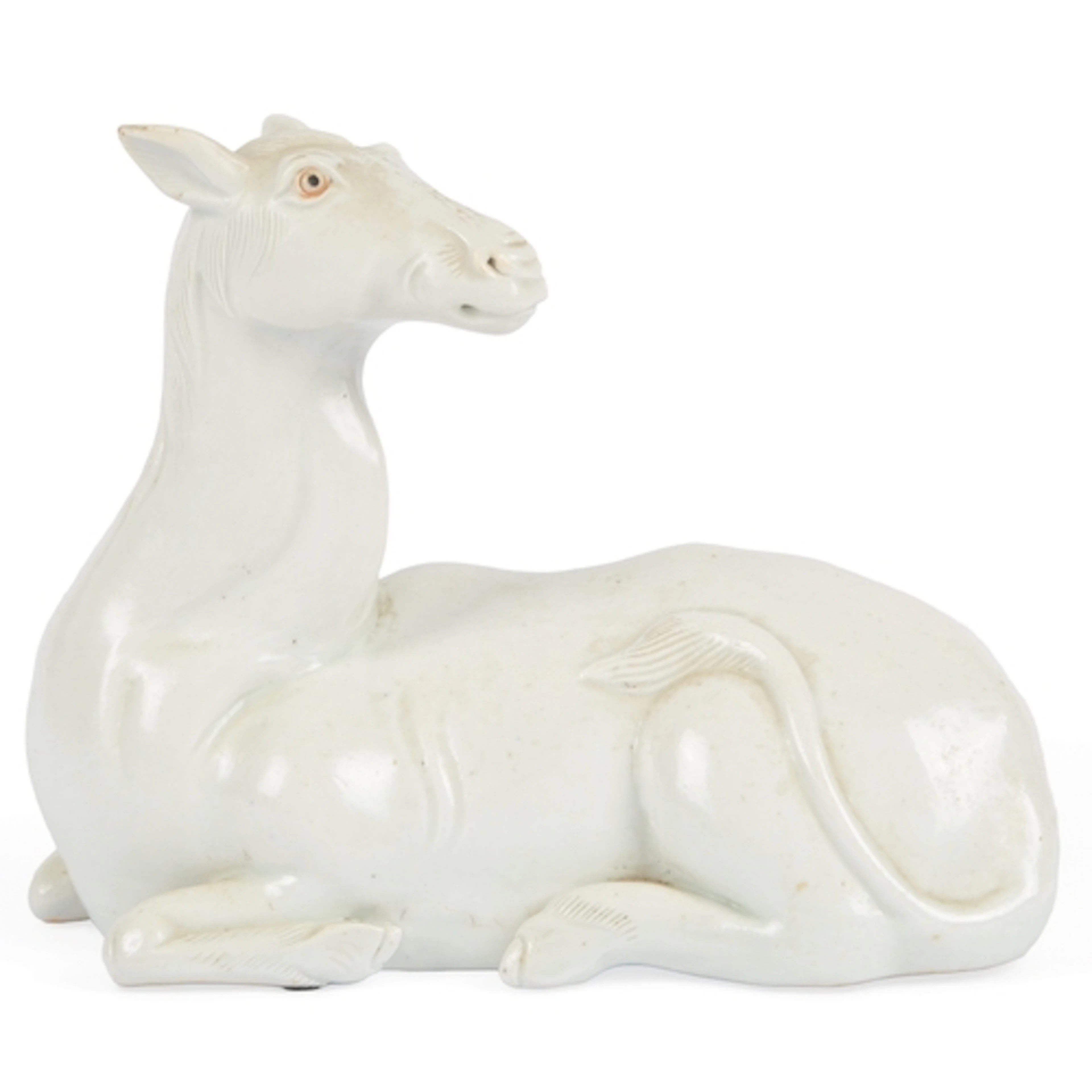 A Japanese Hirado porcelain okimono of a recumbent mule, Mei...