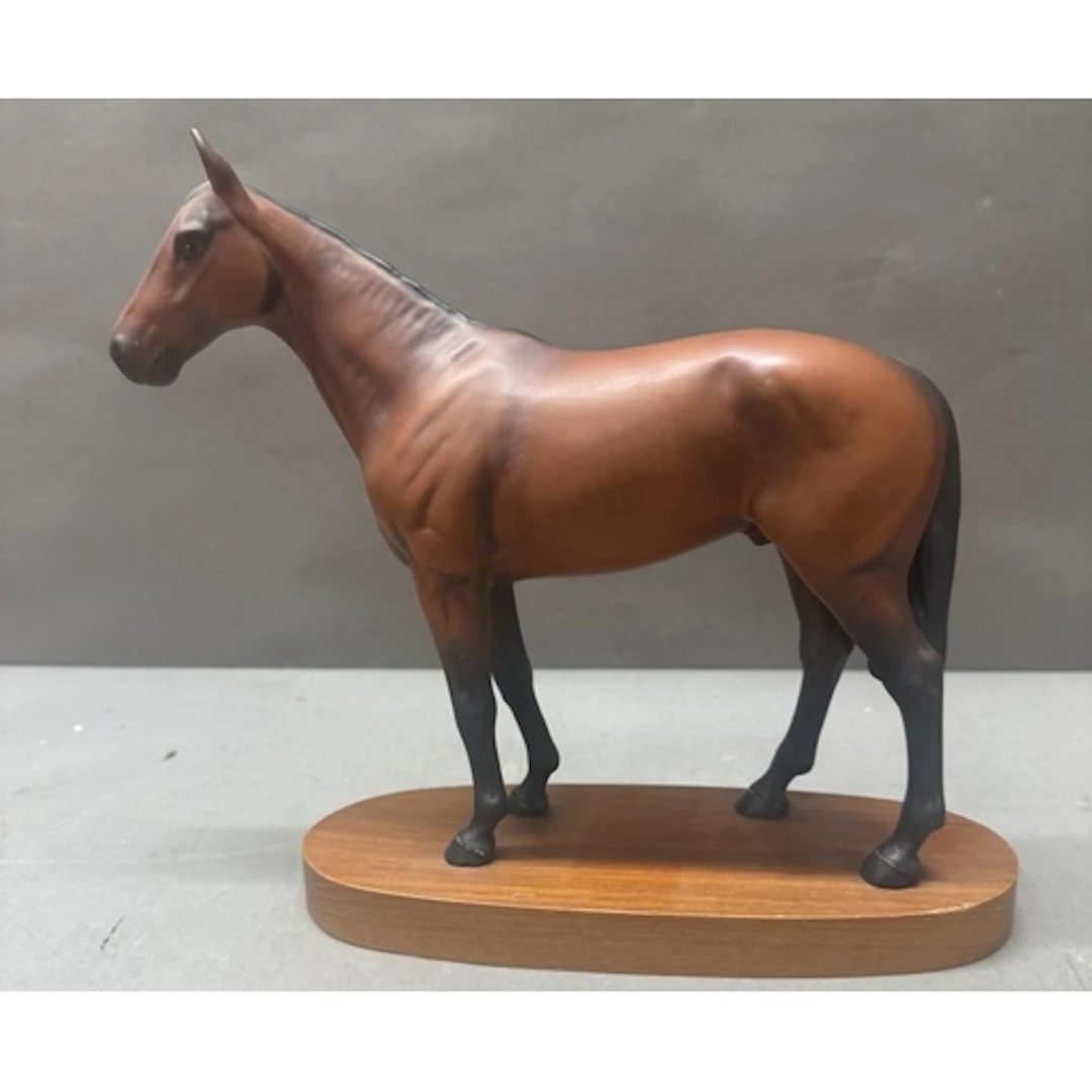 A Beswick figure of a horse on plinth titled Mill Reef. ...