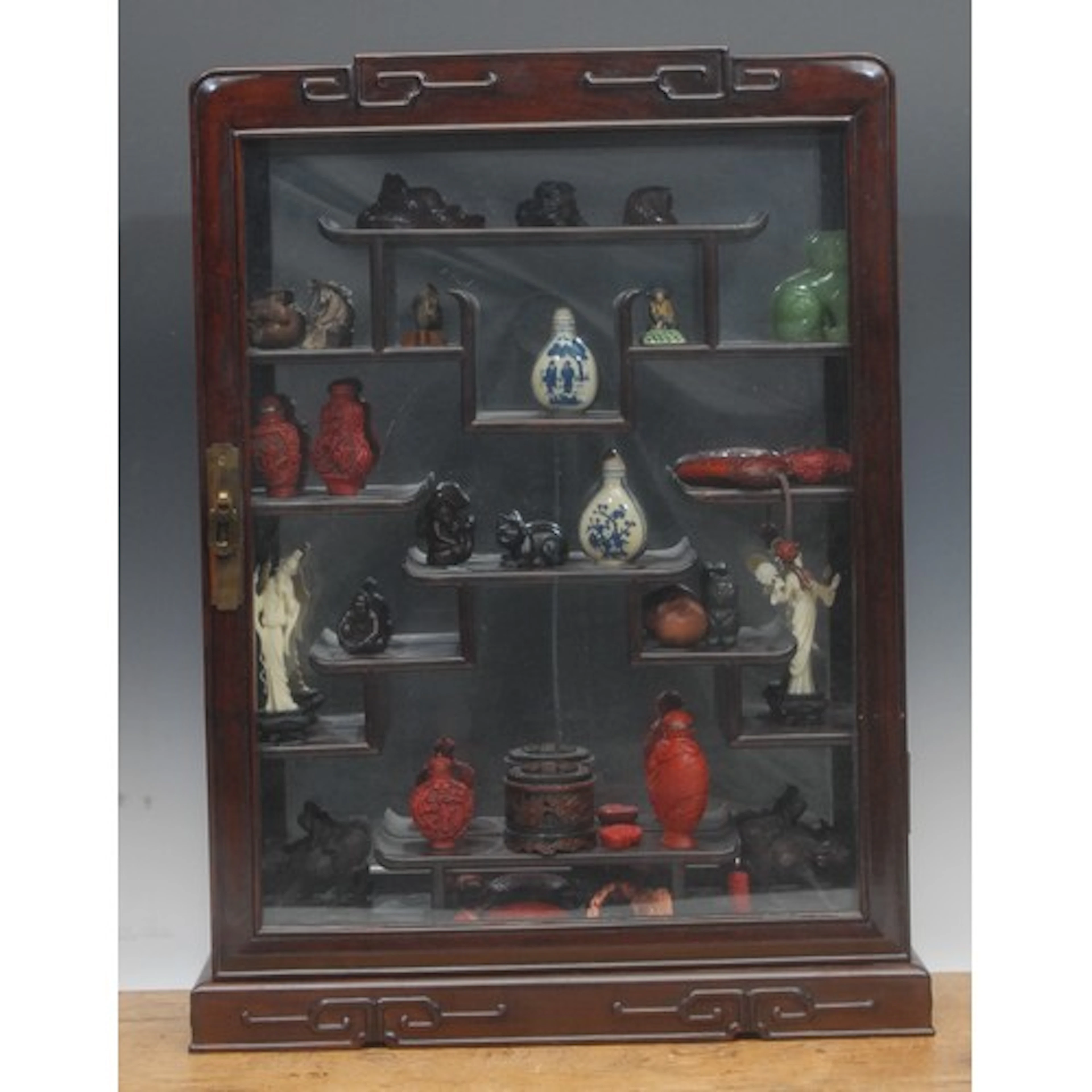 A 20th century Chinese display cabinet with assorted wooden ...