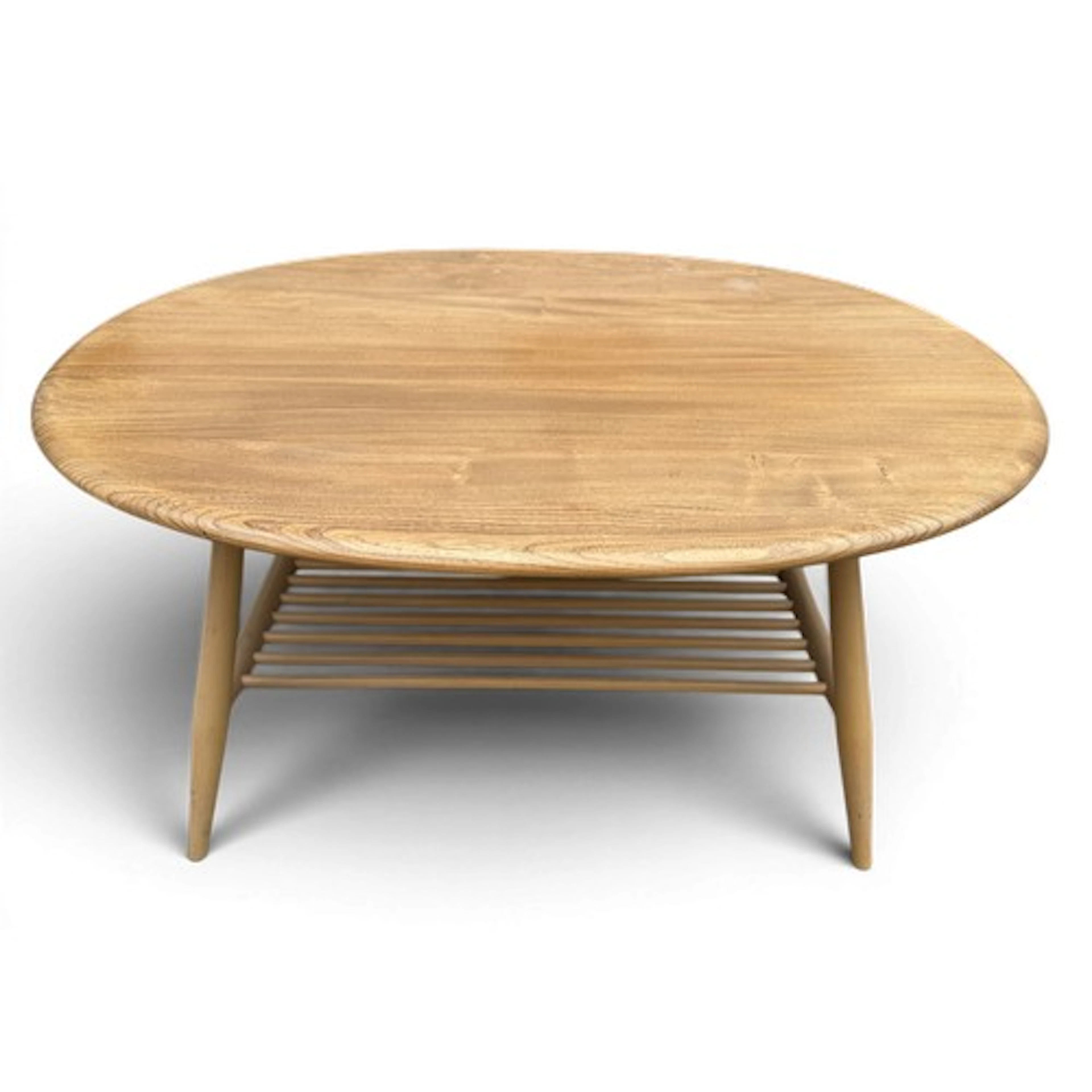 A mid 20thC Ercol oval coffee table with magazine rack under...